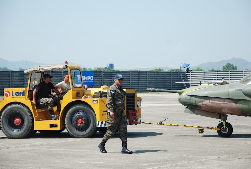 A member of the Honduran Air Force demonstrates aircraft ground operations and supervises the towing procedure of an A-37 Dragonfly aircraft at an air show June 11, 2011, at Colonel Armando Escalon Espinal Air Base, Honduras. This annual event drew more than 10,000 spectators, raised money for a local civilian hospital and emphasized the long history of friendship and cooperation between the U.S. and Honduras. (U.S. Air Force photo/Capt. David McCain)