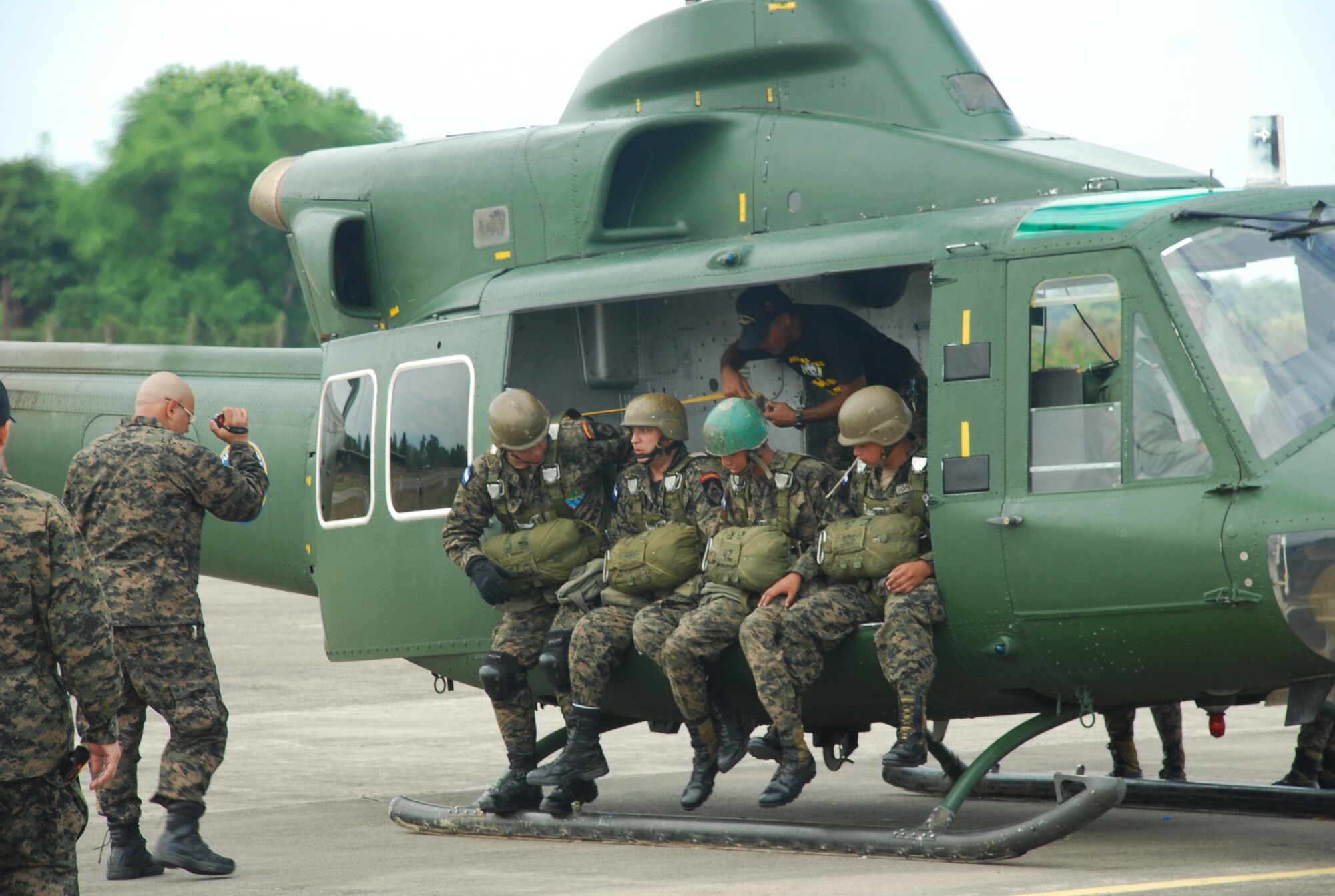 Honduran Army paratroopers prepare to jump from a Bell 412 helicopter here June 12, 2011, at Colonel Armando Escalon Espinal Air Base, Honduras. This annual event drew more than 10,000 spectators, raised money for a local civilian hospital and gave the U.S. and Honduran armed forces the opportunity to build camaraderie through our shared flying culture. (U.S. Air Force photo/Capt. David McCain)
