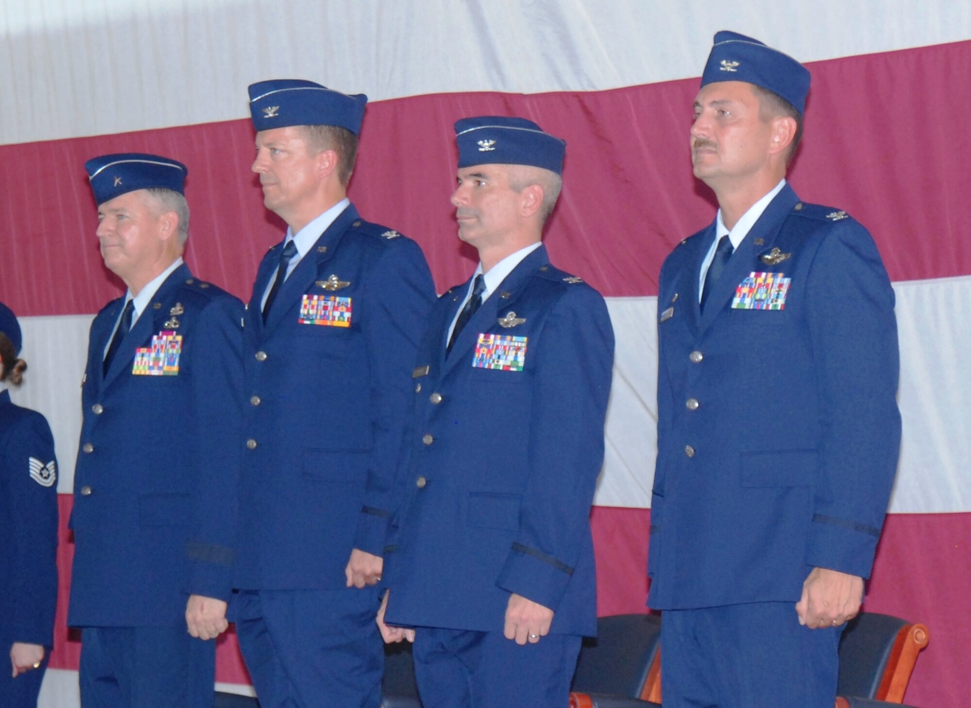 U.S. Air Force Brig. Gen. Joseph Balskus, left, Col. Randy Spear, second from left, Col. Thomas Cucchi, third from left, Col. Scott Barberides, far right, stand at attention during the playing of the Air Force song at the end of the 101st Air & Space Operations Group (101st AOG) change of command ceremony held here June 11, 2011. This was the very first change of command ceremony for the 101st AOG, which was officially activated July 1, 2009. (U.S. Air Force photo by Maj. Steve Burke/Released)