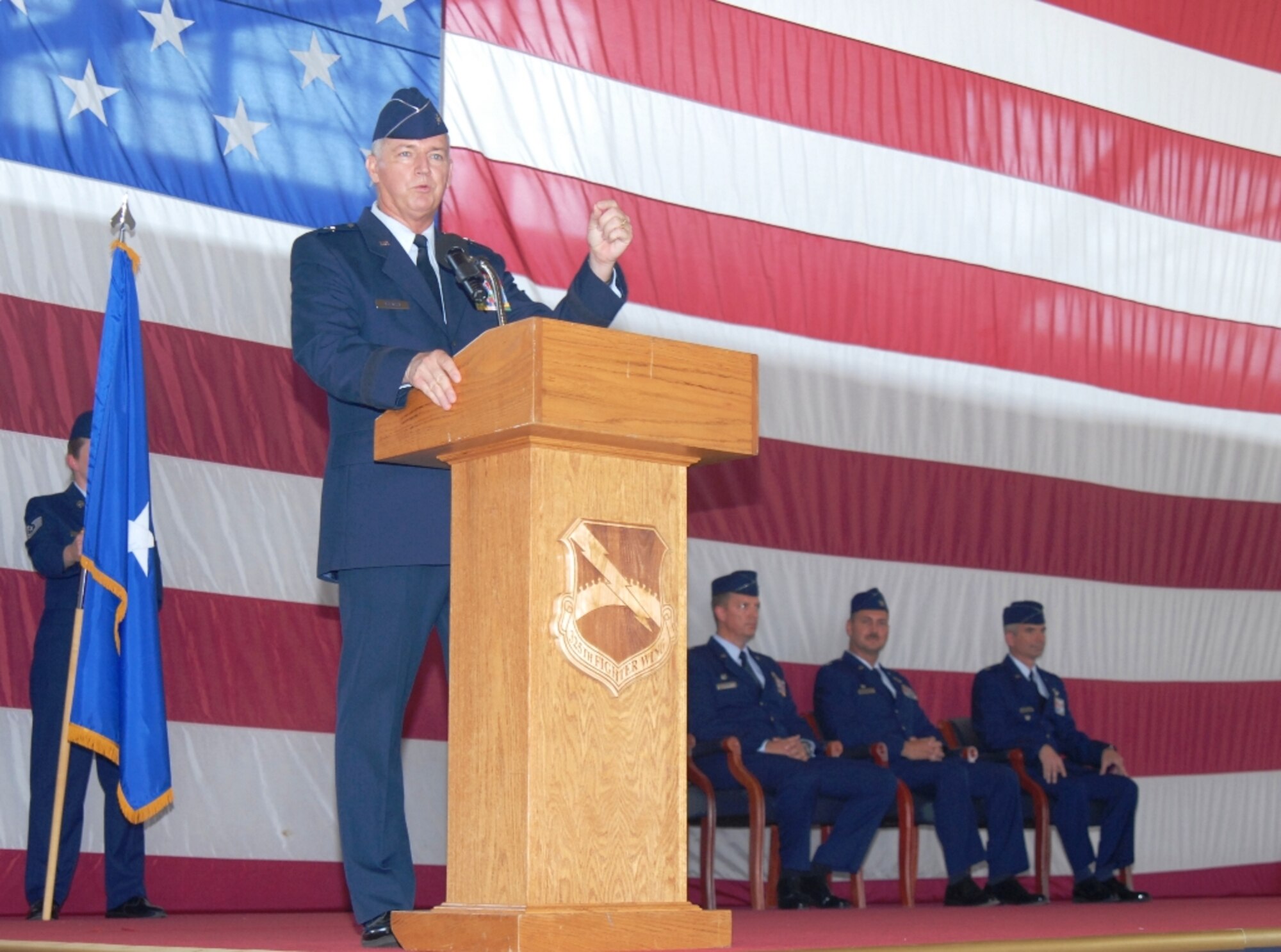 U.S. Air Force Col. Thomas Cucchi, far right, Col. Scott  Barberides, second from right, and Col. Randy Spear, third from right, look on as Brig. Gen. Joseph Balskus addresses family, friends and fellow Airmen during the 101st Air & Space Operations Group (101st AOG) change of command ceremony held here June 11, 2011. This was the very first change of command ceremony for the 101st AOG, which was officially activated July 1, 2009. (U.S. Air Force photo by Maj. Steve Burke/Released)

