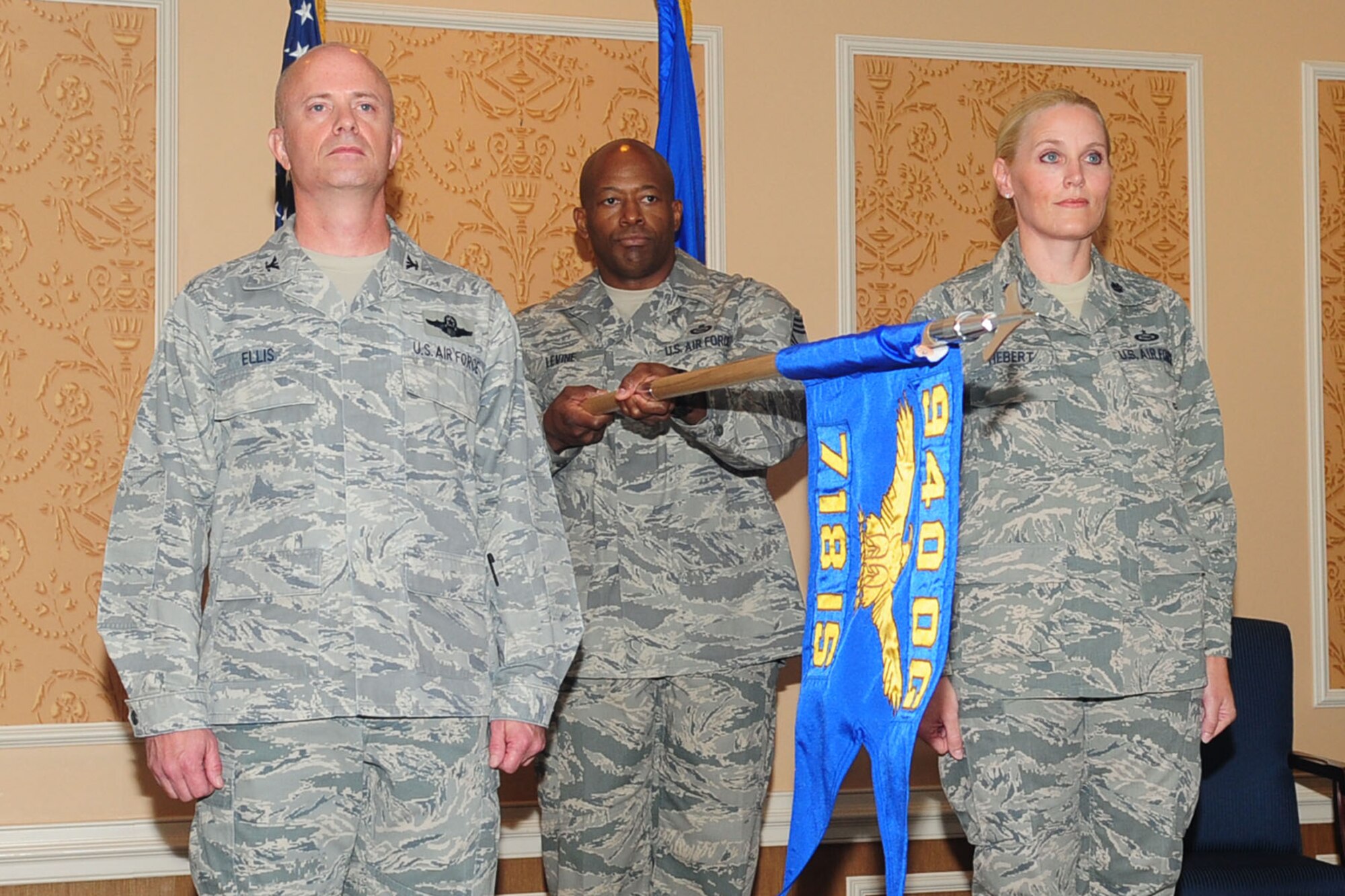 The squadron guidon is presented by Chief Master Sgt. Tony Levine, 718th Intelligence Squadron superintendent, during his unit’s activation ceremony at Langley Air Force Base, Va., June 7, 2011. Lt. Col. Lynnette Herbert (right) assumed command of the 718th IS in the ceremony officiated by Col. Jonathan Ellis (left), 940th Operations Group commander, (U.S. Air Force photo by Staff Sgt. Ashley Hawkins/Released)