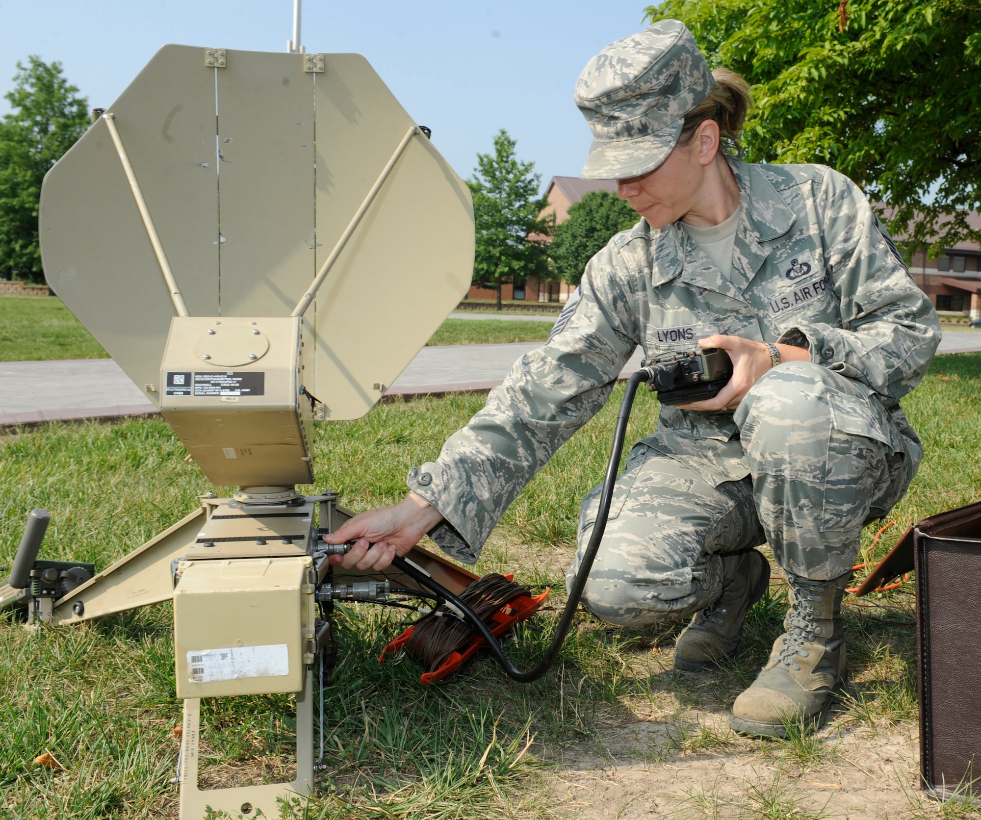 WHITEMAN AIR FORCE BASE, Mo. -- Master Sgt. Jennifer Lyons, 509th Bomb Wing command post NCO in charge of command and control, loads a communication security code to the receiver of the Single Channel Anti-Jam Man Potable (SCAMP) terminal here June 10. The SCAMP is used to receive emergency activation messages from higher headquarters and direct base operations. (U.S. Air Force photo by Senior Airman Alexandra M. Boutte) 