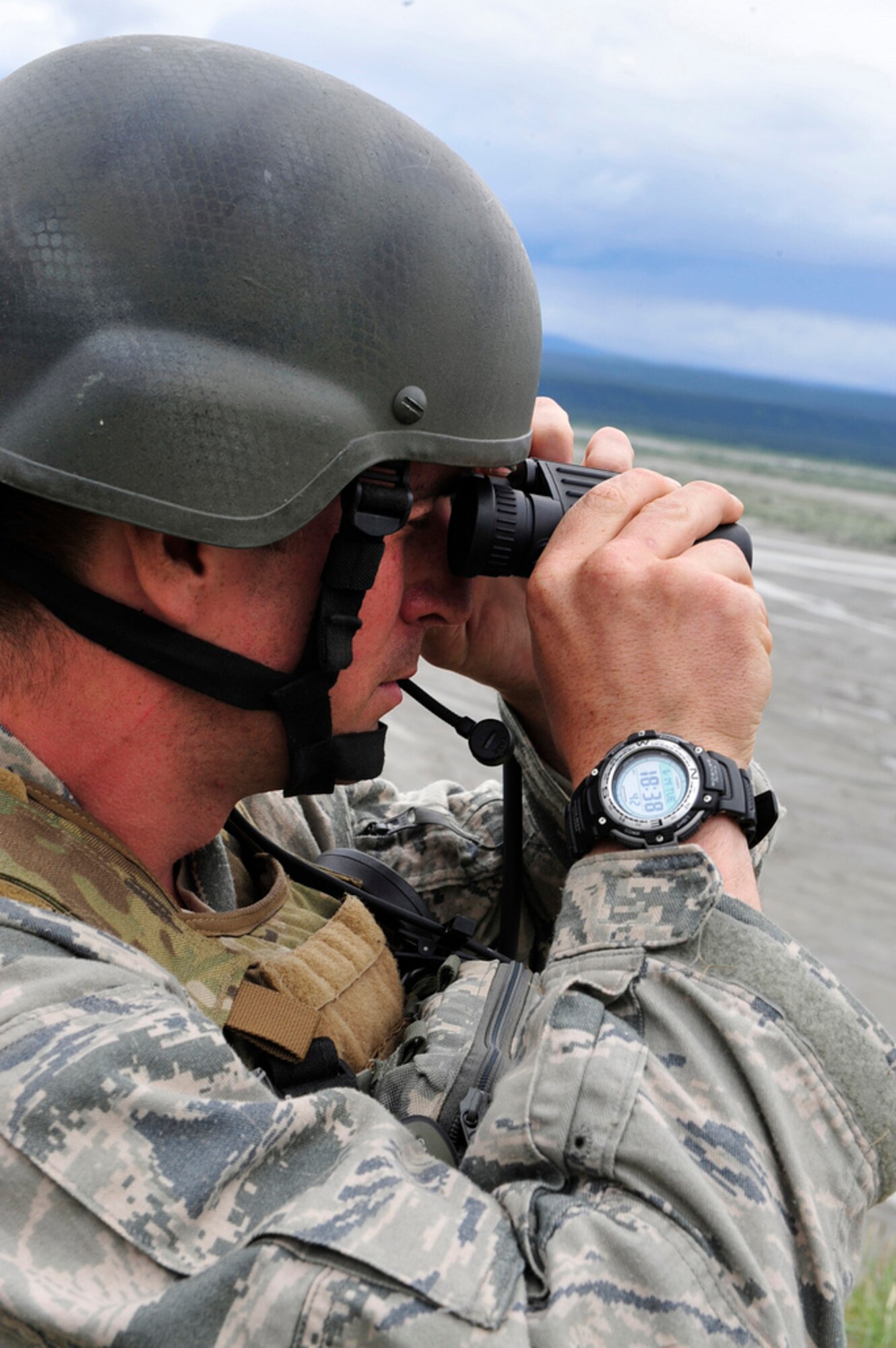 U.S. Air Force Airman Sergio Barcena-Turner, a Tactical Air Control Party member with the 3rd Air Support Operations Squadron, Joint Base Elmendorf-Richardson, Alaska, observes the target area as part of a combined Joint Terminal Attack Controller (JTAC) and Joint Fire Observer (JFO) training scenario during the Northern Edge Premier Joint Training Exercise at the Donnley Training Area, June 14. Northern Edge is designed to be an air-centric exercise to train units in joint air operations tactics and command and control procedures. (U.S. Air Force photo/Staff Sgt. Lakisha A. Croley)