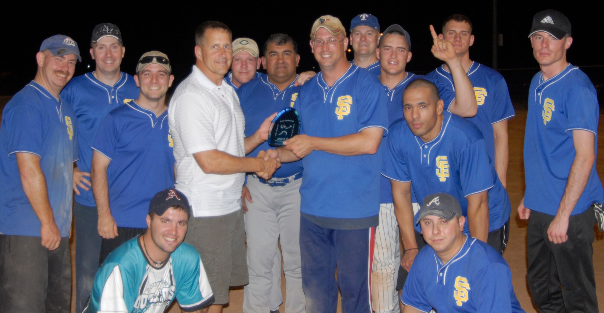 GOODFELLOW AIR FORCE BASE, Texas -- Col. Paul Bugenske, 17th MIssion Support Group Commander, presents the 1st Responders with their first place softball trophy June 15.  The 17th Security Forces Squadron took home the 2011 Base Intramural Softball Championship title after playing three back-to-back games against 2nd place team, 17th Training Support Squadron June 15, (U.S. Air Force photo/Connie Hempel)