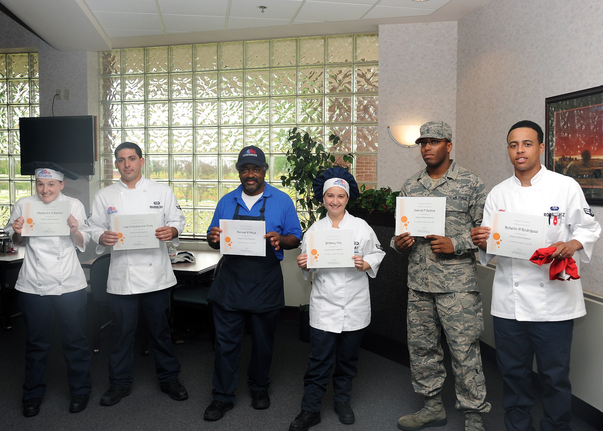 Participants from the Airey Iron Chef Competition smile while receiving their certificates June 15, 2011, after displaying their culinary skills. The competition gave Airmen the opportunity to display their culinary skills and boost morale.  (U.S. Air Force photo by Senior Airman Amber Bennett).