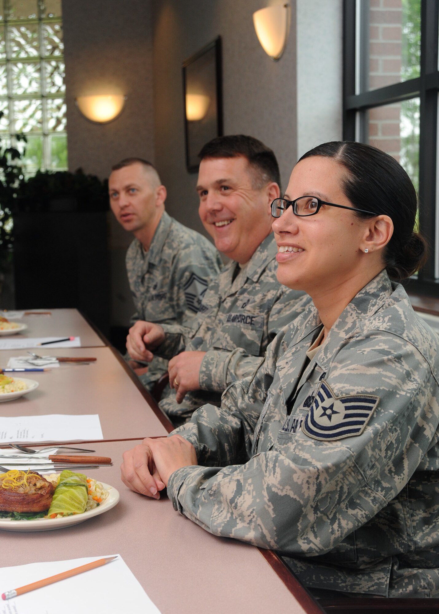 Members of the judging panel happily wait as their meals are served June 15, 2011, during the Airey Iron Chef Competition on Grand Forks Air Force Base, N.D. Following taste tests, judges cast their ballot for the best overall product.  (U.S. Air Force photo by Senior Airman Amber Bennett).