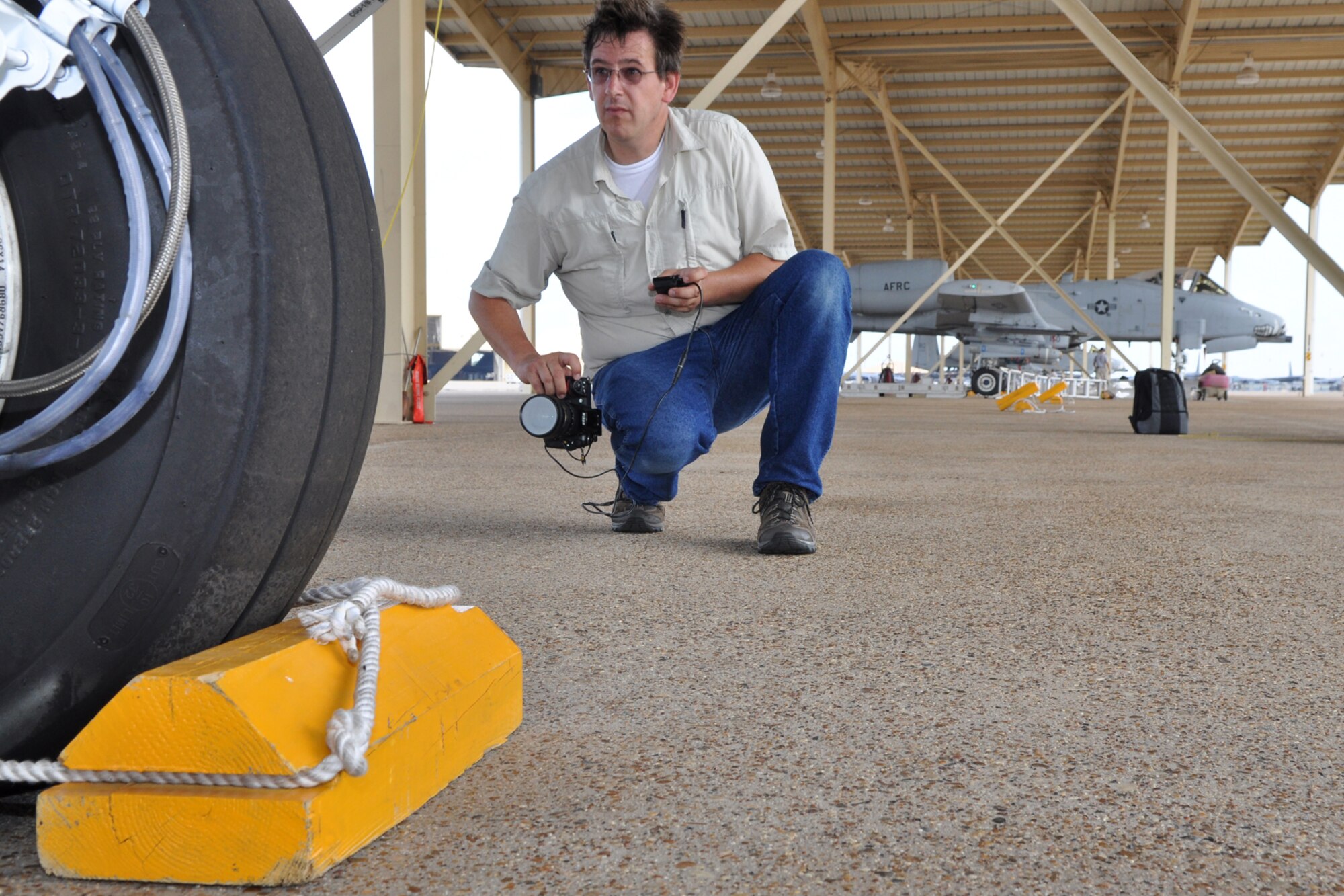 Danny Coremans, an aircraft photographer from Antwerpen, Belgium, uses a remote digital view finder with an LCD display to capture images of an A-10 Thunderbolt II for his new book during a visit to Barksdale Air Force Base, La., June 15, 2011. Mr. Coremans, who has traveled the world to photograph different military aircraft, has published eight books worldwide, with his ninth, a book about the Lockheed F-104 Starfighter, scheduled to be released later this year. Mr. Coremans is a former F-16 crew chief for the Belgium air force. He is currently working on a book about the A-10 Thunderbolt, which is scheduled for release in 2012. (U.S. Air Force photo/Tech. Sgt. Jeff Walston)            