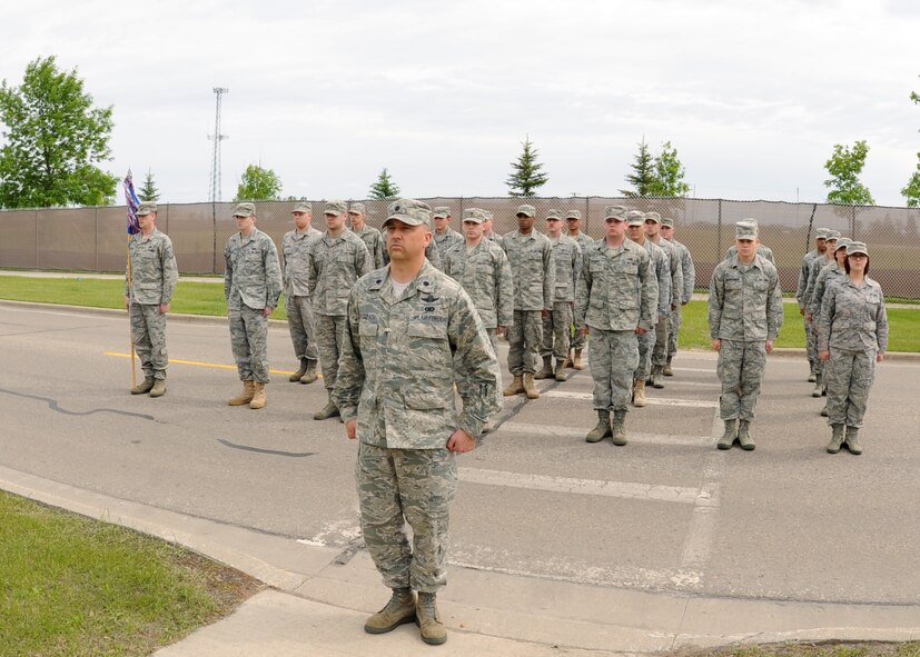 Members of the 319th Operation Support Squadron participate in the Retreat Ceremony June 10, 2011 on Grand Forks Air Force Base, N.D.  The base will have different Squadrons perform retreat until the Friday before Labor Day.  The Retreat Ceremony serves a twofold purpose – it both signals the end of the duty day and serves as a ceremony for paying respect to the flag. (U.S. Air Force photo by Senior Airman Amber Bennett)