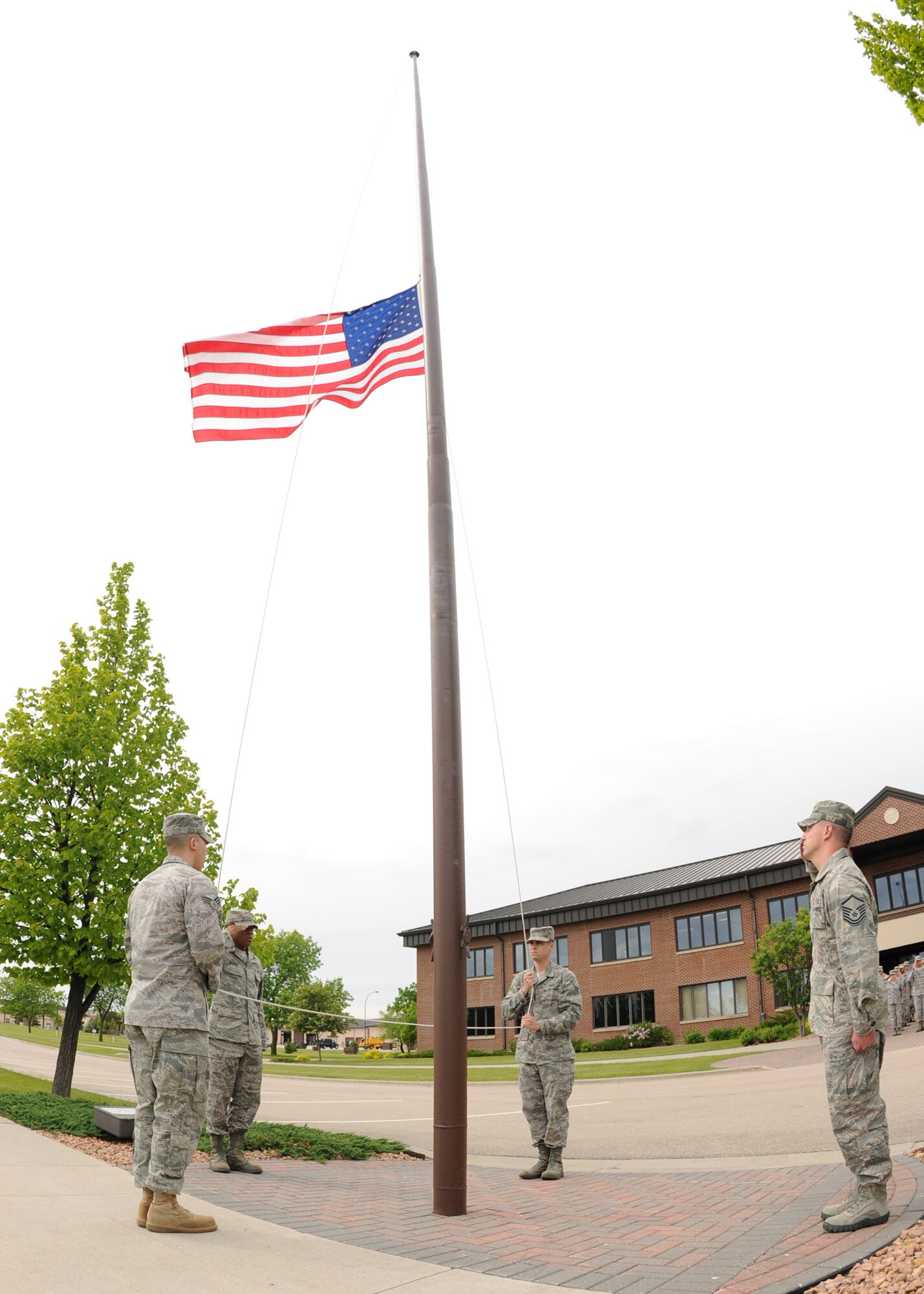 Members of the 319th Operation Support Squadron participate in the Retreat Ceremony June 10, 2011 on Grand Forks Air Force Base, N.D. The base will have different Squadrons perform retreat until the Friday before Labor Day. The Retreat Ceremony serves a twofold purpose -- it both signals the end of the duty day and serves as a ceremony for paying respect to the flag. (U.S. Air Force photo by Senior Airman Amber Bennett)