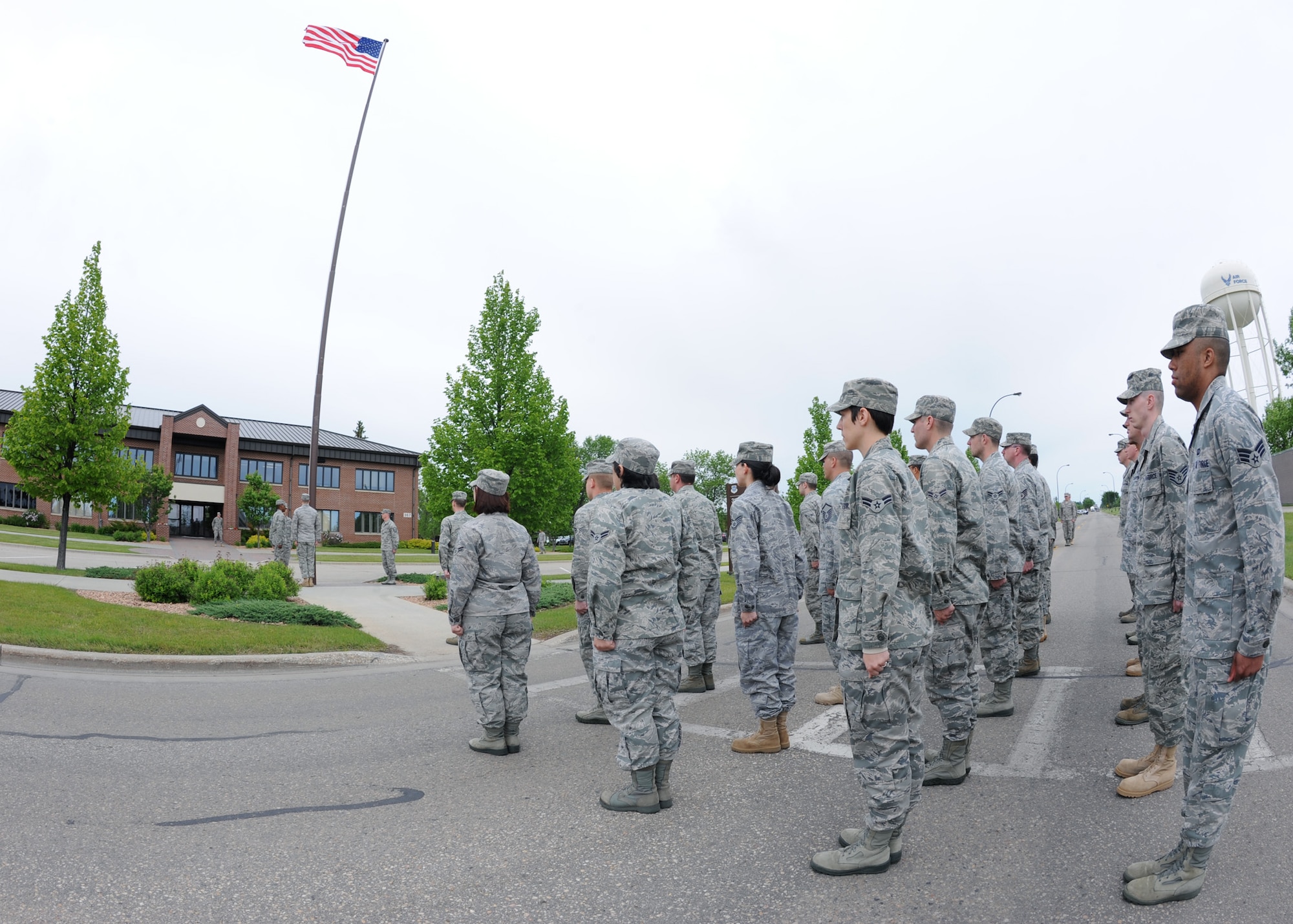 Members of the 319th Operation Support Squadron participate in the Retreat Ceremony June 10, 2011 on Grand Forks Air Force Base, N.D. The base will have different Squadrons perform retreat until the Friday before Labor Day. The Retreat Ceremony serves a twofold purpose -- it both signals the end of the duty day and serves as a ceremony for paying respect to the flag. (U.S. Air Force photo by Senior Airman Amber Bennett)