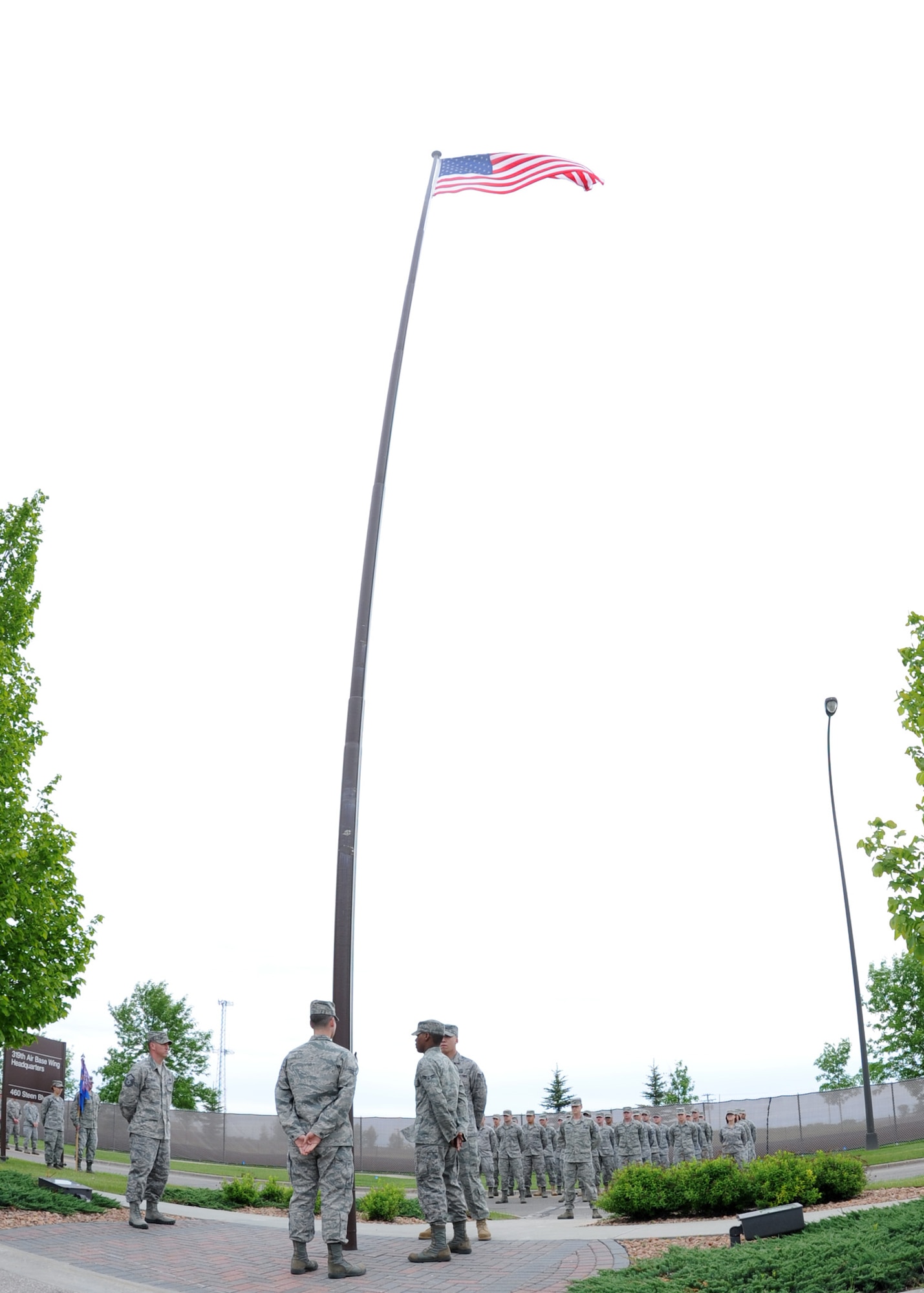 Members of the 319th Operation Support Squadron participate in the Retreat Ceremony June 10, 2011 on Grand Forks Air Force Base, N.D. The base will have different Squadrons perform retreat until the Friday before Labor Day. The Retreat Ceremony serves a twofold purpose -- it both signals the end of the duty day and serves as a ceremony for paying respect to the flag. (U.S. Air Force photo by Senior Airman Amber Bennett)