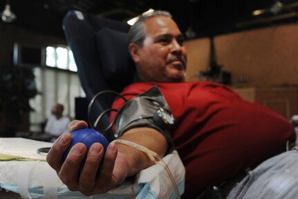 Andrew Ramos, 902nd Civil Engineer Squadron, squeezes a stress ball while donating blood June 10 blood drive at the Kendrick Club on Randolph Air Force base. The blood drive was hosted by the Lackland AFB Blood Donor Center. (U.S. Air Force photo/Rich McFadden) (released)