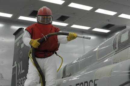 Daniel Perez, 12th Flying Training Wing Maintenance Division, prepares to strip the paint off of a T-38 Talon aircraft from Laughlin Air Force Base in the media blast booth at Randolph Air Force Base June 9, 2011. (U.S. Air Force photo/Airman Alexis Siekert) (released)