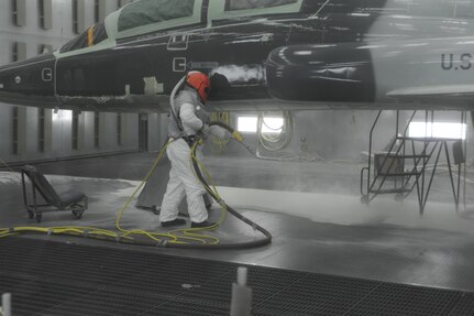 Johnny Esquivel, 12th Flying Training Wing Maintenance Division, prepares to strip the paint off of a T-38 Talon aircraft from Laughlin Air Force Base in the media blast booth at Randolph Air Force Base June 9, 2011. (U.S. Air Force photo/Airman Alexis Siekert) (released)