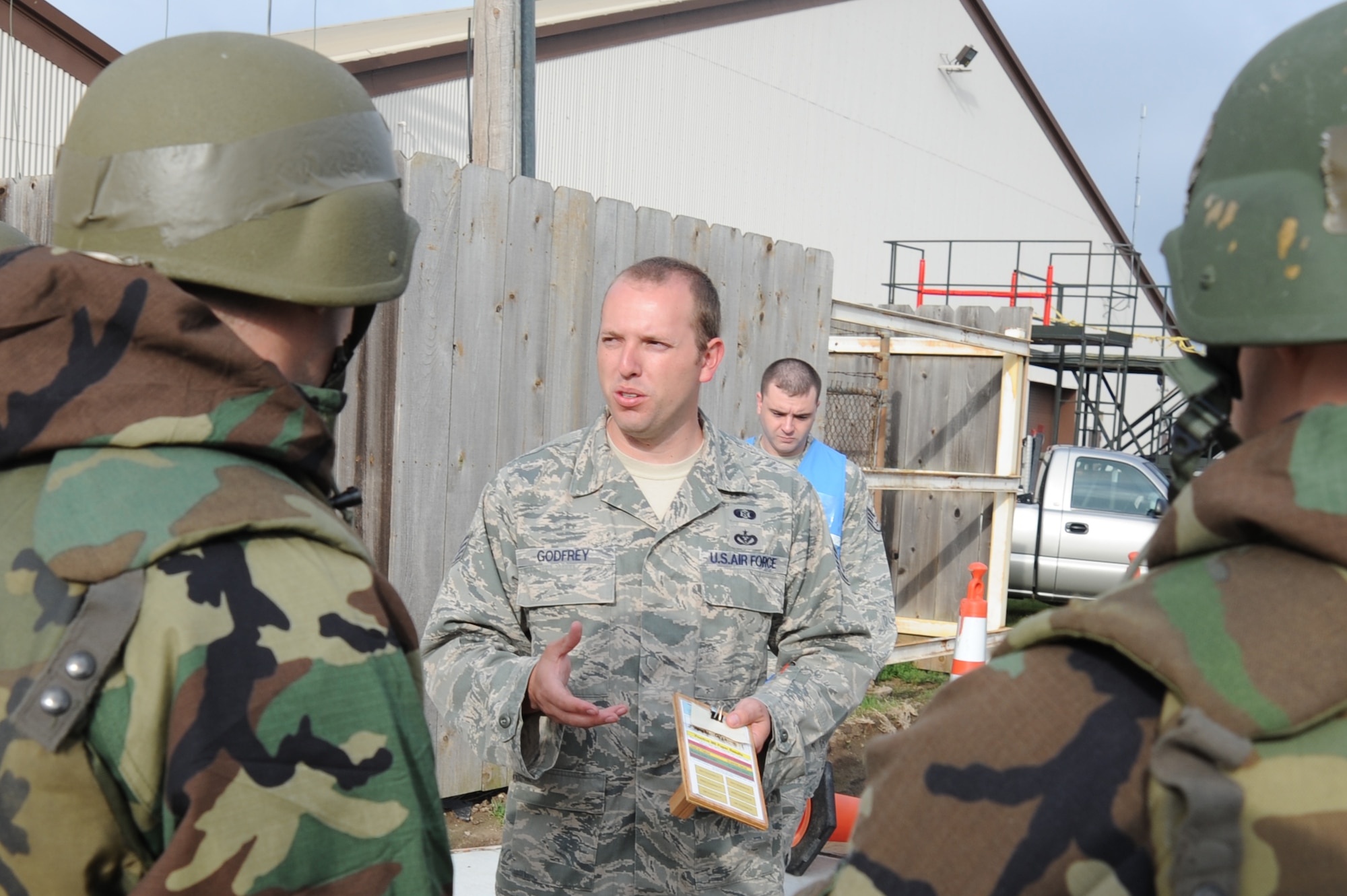 Staff Sgt. Greg Godfrey, 22nd Civil Engineer Squadron readiness and emergency management journeyman, instructs McConnell Airmen during an operational readiness exercise May 12, 2011, McConnell Air Force Base, Kan.  Sergeant Godfrey, along with other REM personnel, trains Airmen how to survive when chemical, biological, radiological, nuclear and high-yield explosives are present.  (U.S. Air Force photo/Staff Sgt. Dallas Edwards)