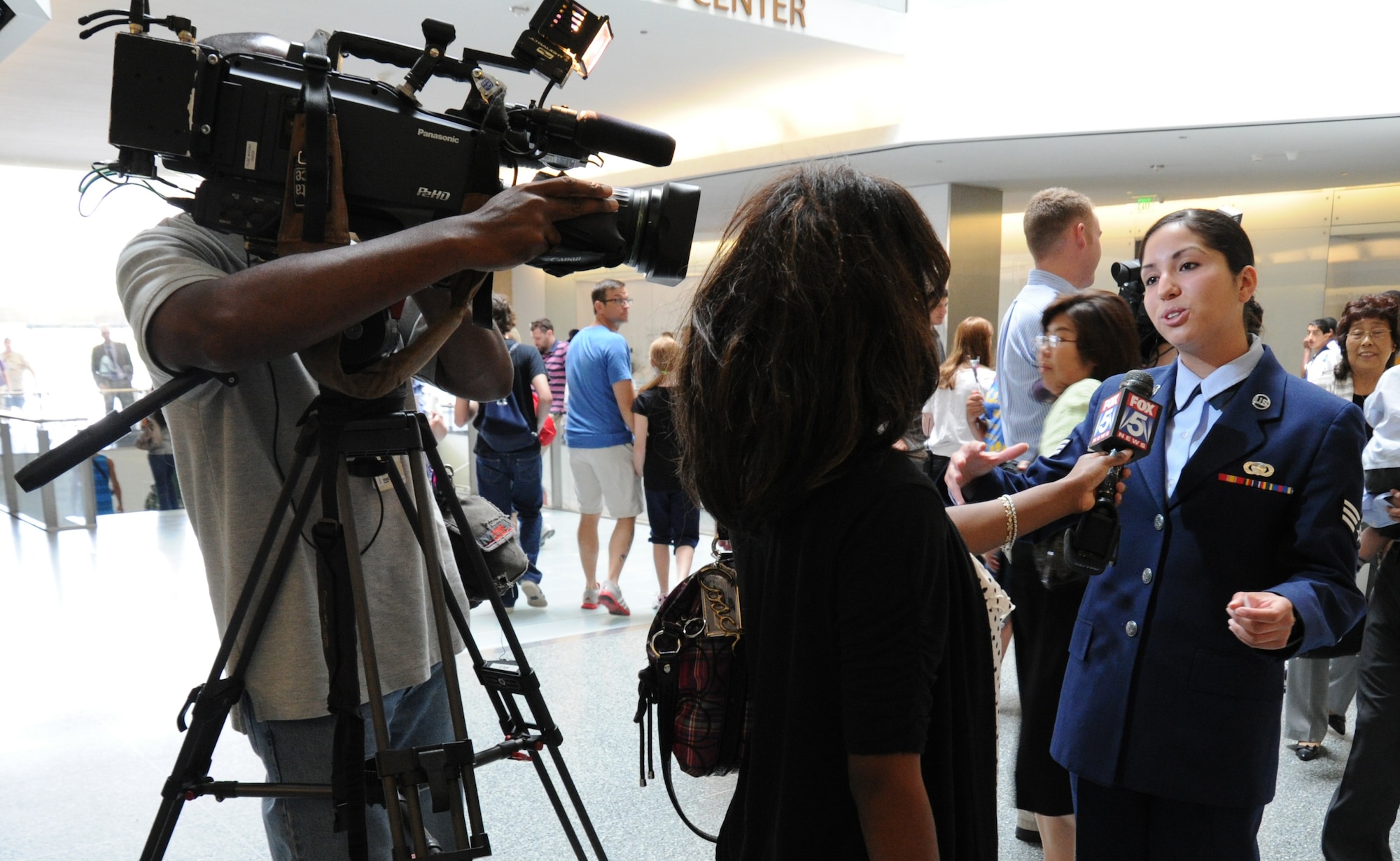 WASHINGTON –A WTTG FOX 5 intern interviews Senior Airman Deborah Vives, 11th Comptroller Squadron customer service technician, after her participation in a naturalization ceremony at the Smithsonian National Museum of American History here June 14. Airman Vives took the Oath of Allegiance and became an American citizen along with 19 other new citizens. (U.S. Air Force photo by Airman 1st Class Bahja J. Jones) 