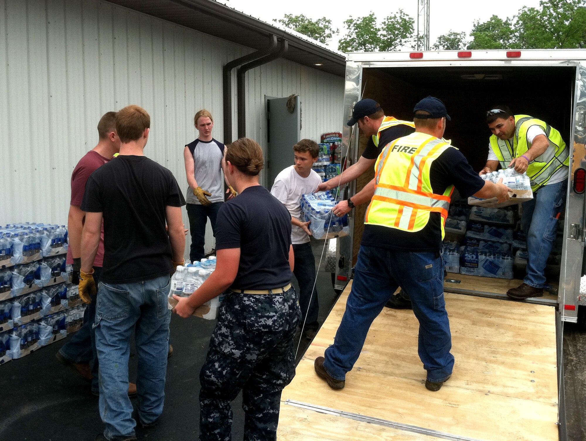 Reserve Officer Training Corps cadets and civilian volunteers unload bottled water at the city hall in Joplin, Mo., May 24, 2011.  A tornado detroyed much of the town on May 22, 2011. Cadets from all military services in the state of Missouri quickly responded to the need for volunteers.  (courtesy photo)(RELEASED)
