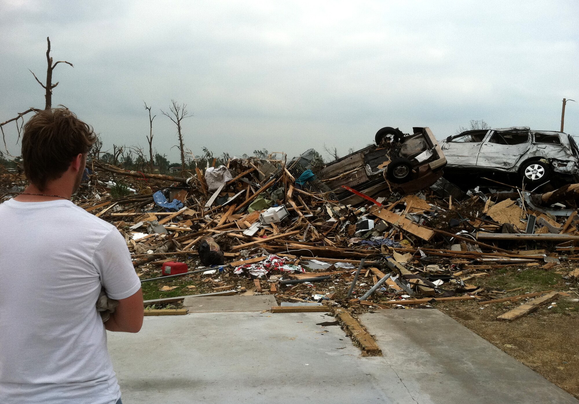 Casey Steen, a New Mexico State University student, surveys damage in the primarily residential town of Joplin, Mo., May 24, 2011. A tornado detroyed much of the town on May 22, 2011.  The 10-hour relief trip is the farthest Steen has ever traveled from his hometown of Portales, N.M.  (courtesy photo)(RELEASED)
