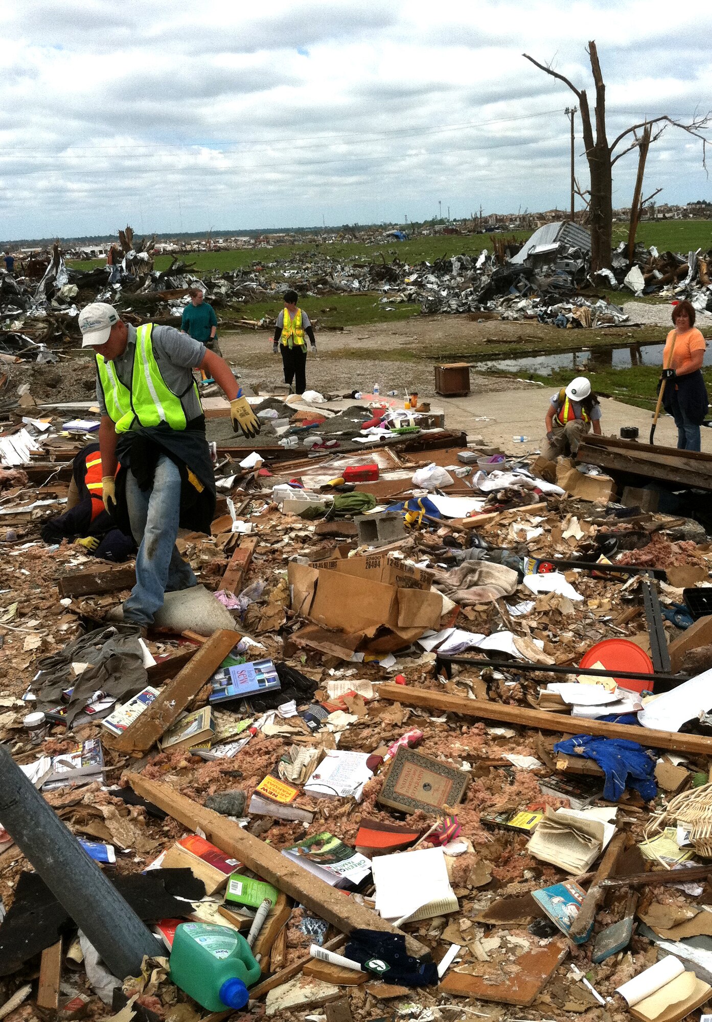 Volunteers search through piles of rubble for survivors and salvagable household items in Joplin, Mo., May 25, 2011.  In addition to search and rescue missions, volunteers handed out bottled water and assisted Joplin residents after the town was hit by tornado on May 22, 2011. (courtesy photo)(RELEASED)