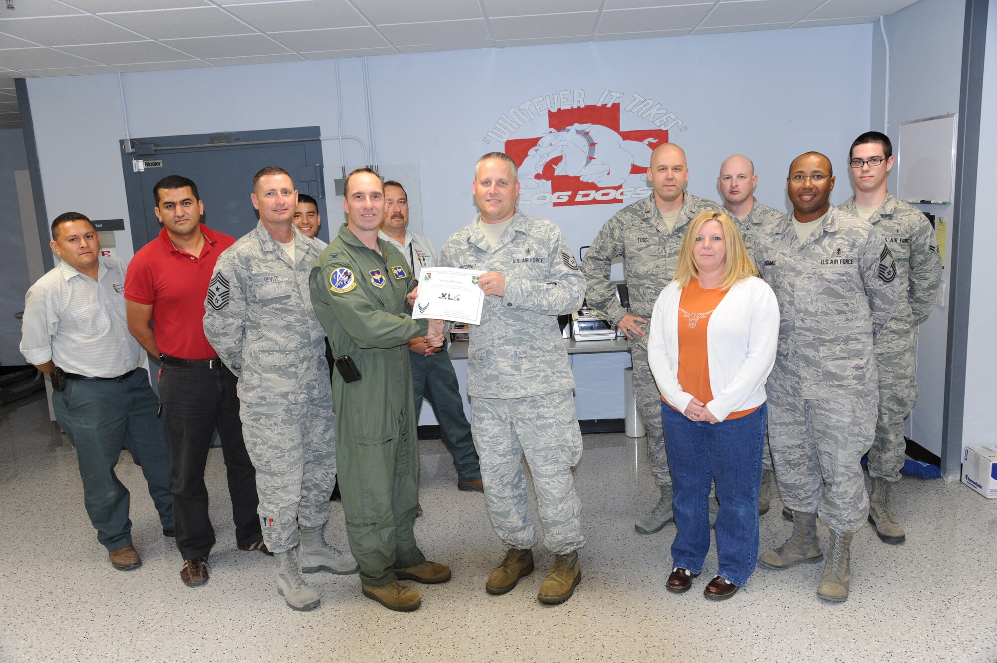 LAUGHLIN AIR FORCE BASE, Texas – Tech. Sgt. Sean Biscornet, 47th Medical Support Squadron, poses with Col. Thomas Murphy, 47th Flying Training Wing vice commander, and fellow members of his squadron after being presented the XLer of the Week award here June 15. The XLer is a weekly award chosen by wing leadership and given to those who consistently make outstanding contributions to Laughlin and their unit. (U.S. Air Force photo by Airman 1st Class Blake Mize)