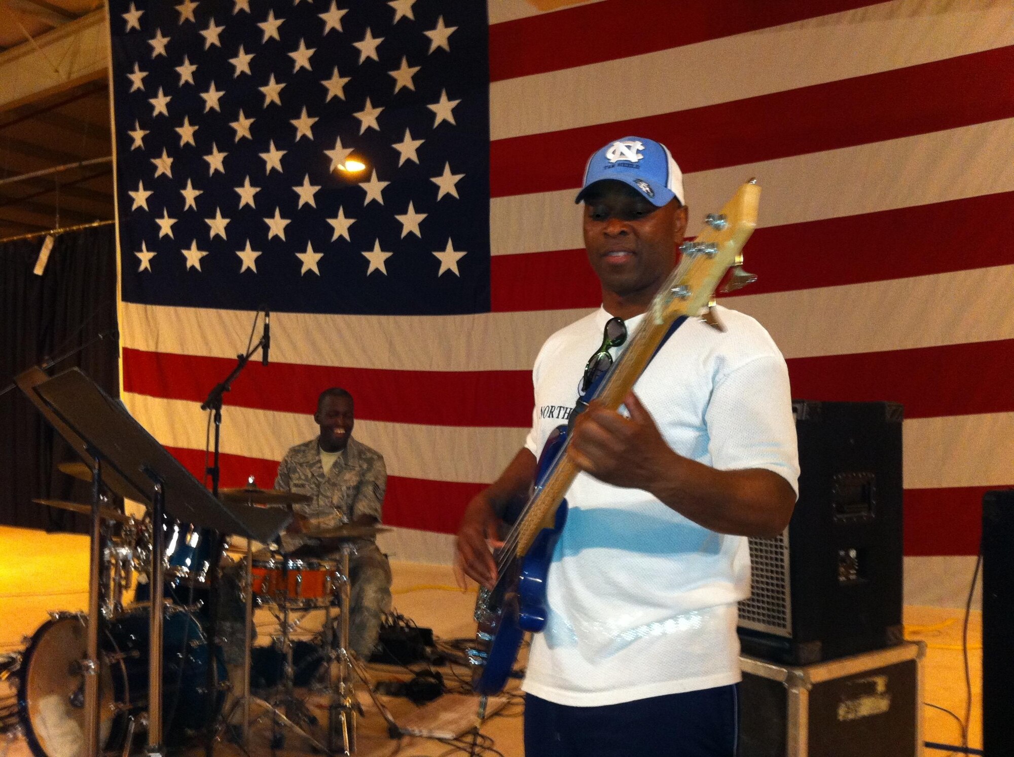 Army Command Sgt. Maj. Charles Holiday, Sr., plays The Temptation's "Just My Imagination" on an electric bass as Blue Hawk's Staff Sgt. Curtis Simmons plays the drums June 8 at an undisclosed location in Southwest Asia. (U.S. Air Force courtesy photo)