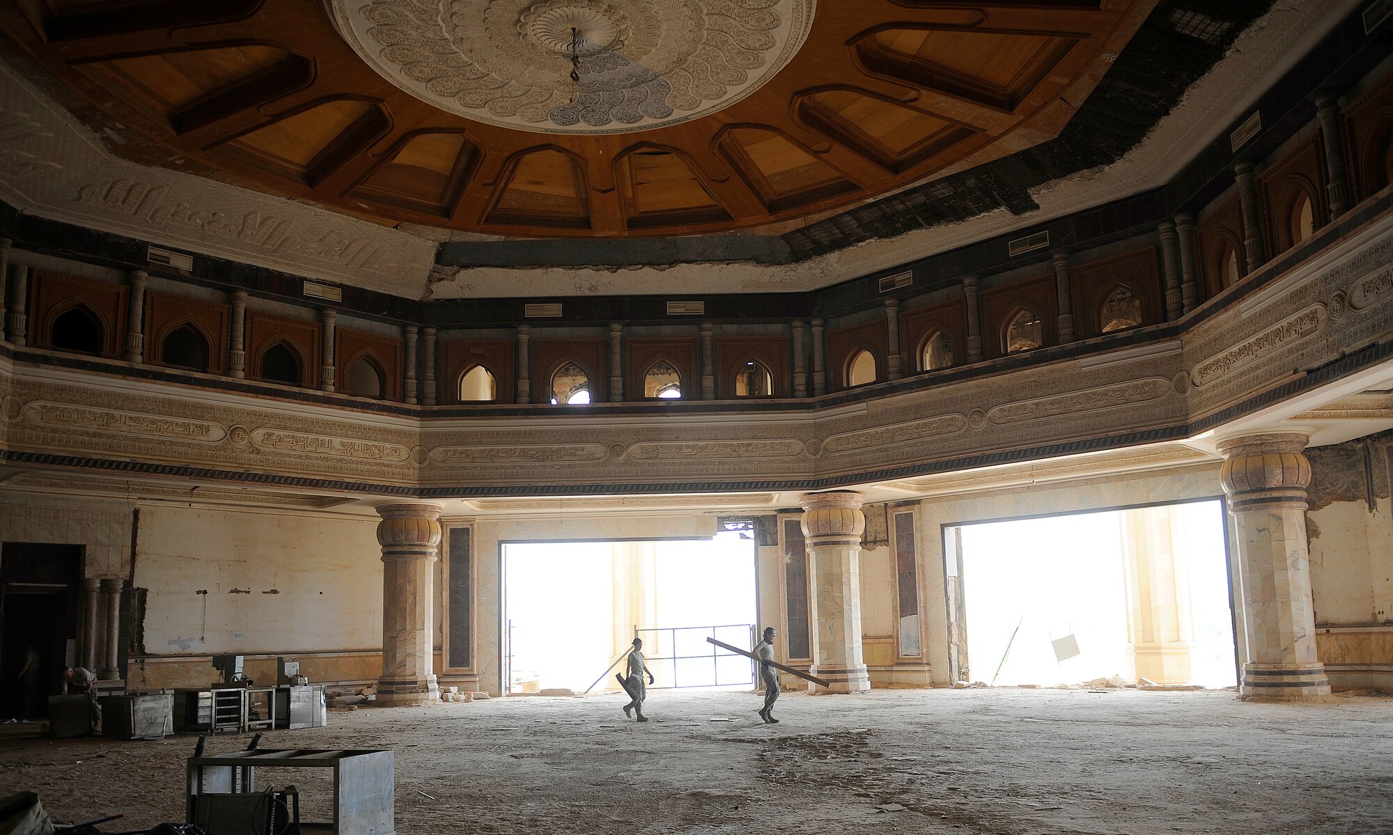 BAGHDAD, Iraq -- Staff Sgt. Alexis Johnson and Staff Sgt. Nicole Beye from the 447th Expeditionary Operations Support Squadron, carry out debris during a three-day cleanup effort at Victory Over America Palace June 11. Sergeant Johnson and Beye are both deployed from Offutt Air Force Base, Neb. Sergeant Johnson's hometown is Debary, Fla. Sergeant Beye's hometown is Offutt AFB, Neb. (U.S. Air Force/Tech. Sgt. Jason Lake)