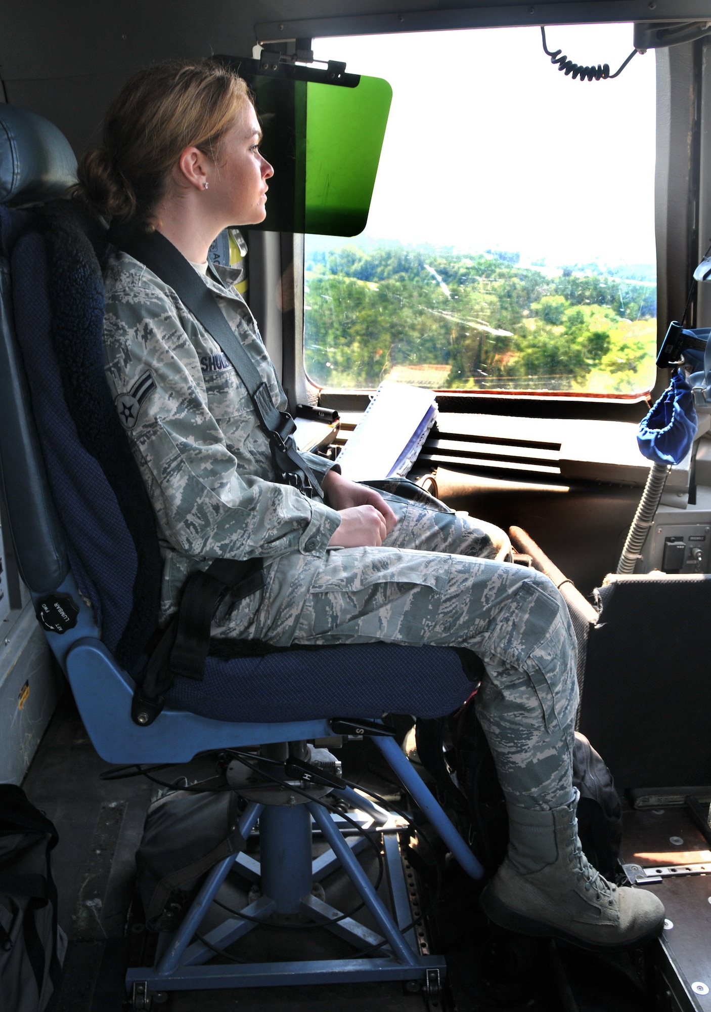 Airman 1st Class Maechelle Shuler, from the 628th Air Base Wing legal office, looks outside the window of a C-17??s cockpit during landing June 15 at Joint Base Charleston - Northfield. During the flight training mission, 32 Airmen and two civilians from the 437th Airlift Wing and the 628th Air Base Wing participated in a quarterly C-17 incentive flight. (U.S. Air Force photo/ Airman 1st Class Jared Trimarchi)
