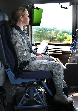 Airman 1st Class Maechelle Shuler, from the 628th Air Base Wing legal office, looks outside the window of a C-17??s cockpit during landing June 15 at Joint Base Charleston - Northfield. During the flight training mission, 32 Airmen and two civilians from the 437th Airlift Wing and the 628th Air Base Wing participated in a quarterly C-17 incentive flight. (U.S. Air Force photo/ Airman 1st Class Jared Trimarchi)
