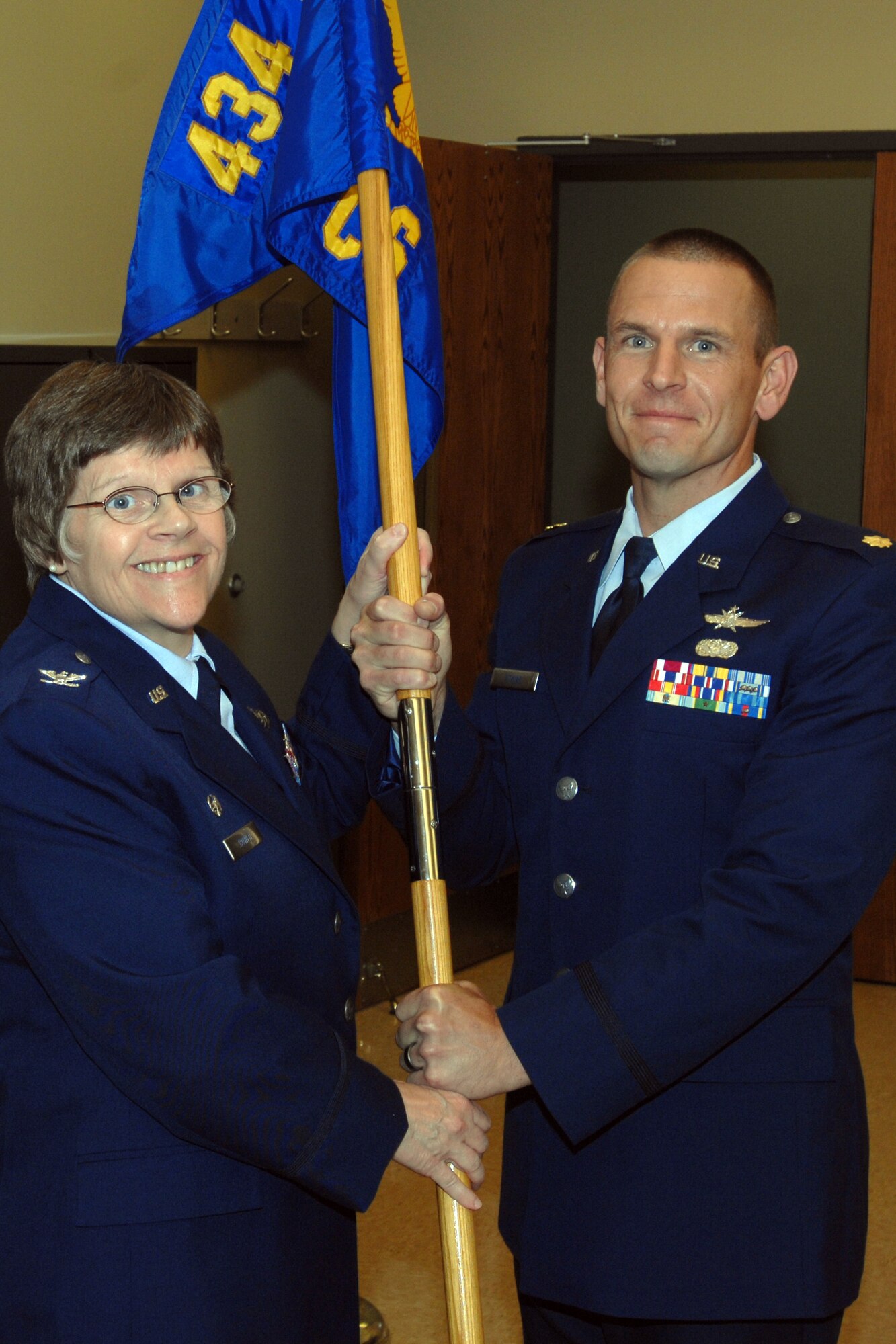 GRISSOM AIR RESERVE BASE, Ind. -- Col. Betty Bowen, 434th Mission Support Group commander, presents the 434th Communications Squadron flag to Maj. Robert Atkins, as he takes command of the unit, during an assumption of command ceremony. (U.S. Air Force photo/Staff Sgt. Carl Berry)