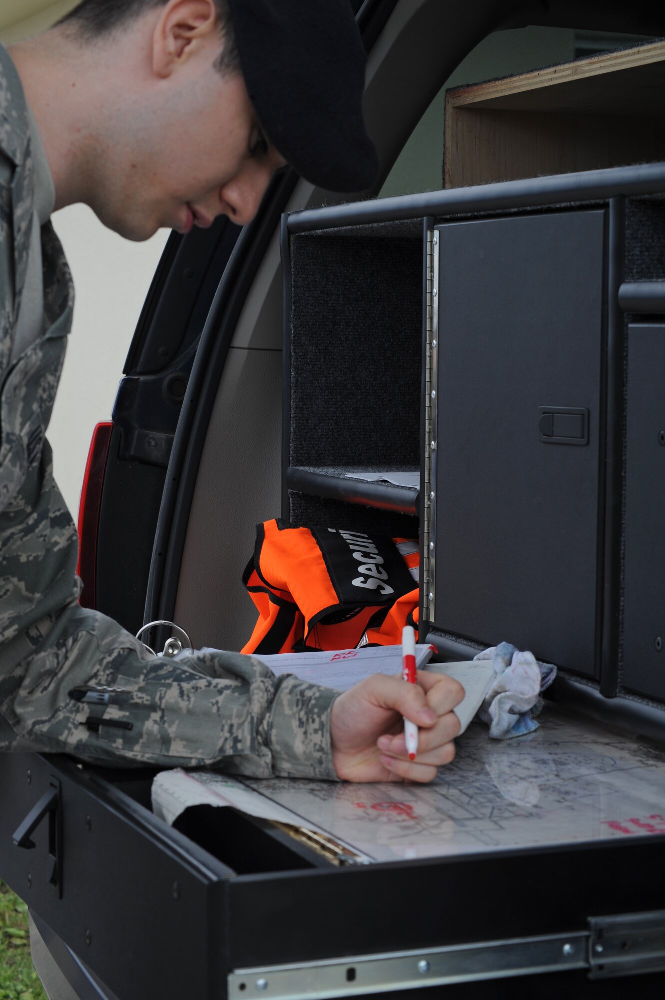 MISAWA AIR BASE, Japan -- Tech. Sgt. Justin Aguilar, 35th Security Forces Squadron flight sergeant, plots out an area of containment during a training exercise June 15.  Training exercises are held periodically throughout the year to maintain operational readiness. (U.S. Air Force photo/Staff Sgt. April Quintanilla)