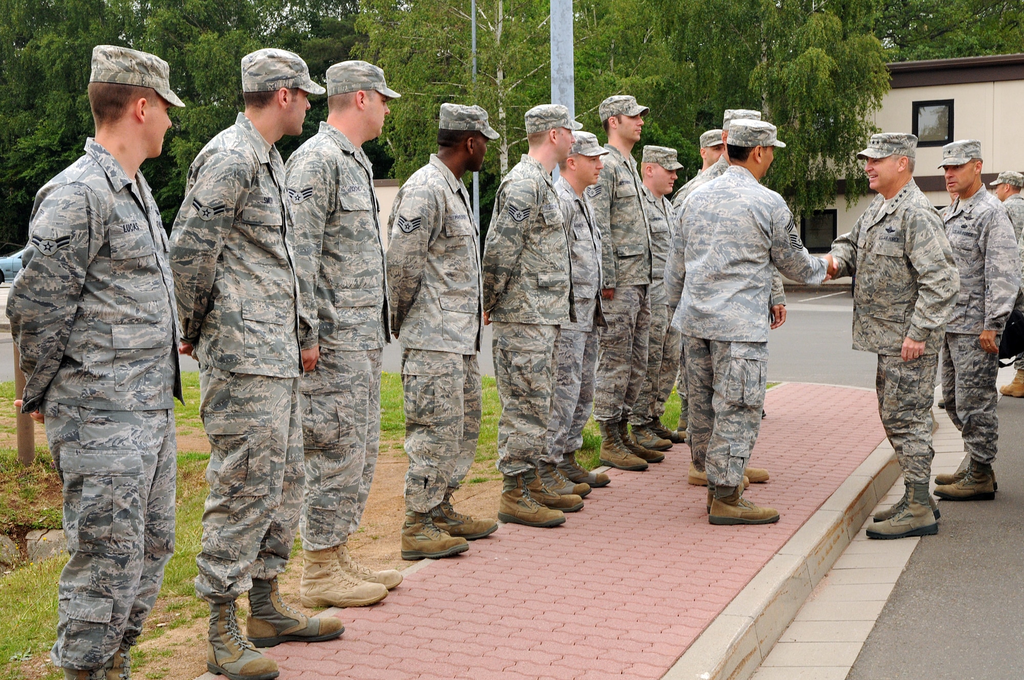 Chief Master Sgt.  Ricardo Robelin, 86th Communications Squadron superintendent, and several other 86th CS Airmen shake hands and greet Gen. Mark A. Welsh III, U.S. Air Forces in Europe commander, outside of the satellite communications facility as part of his immersion with the 86th Airlift Wing, Ramstein Air Base, Germany, June 15.  This visit gave General Welsh along with Chief Master Sgt. David Williamson, USAFE command chief, the opportunity to see how the Airmen of the 86th AW support contingency operations and build strong partnerships capacities in Europe and throughout the world. (U.S. Air force photo by Staff Sgt. Tyrona Lawson)