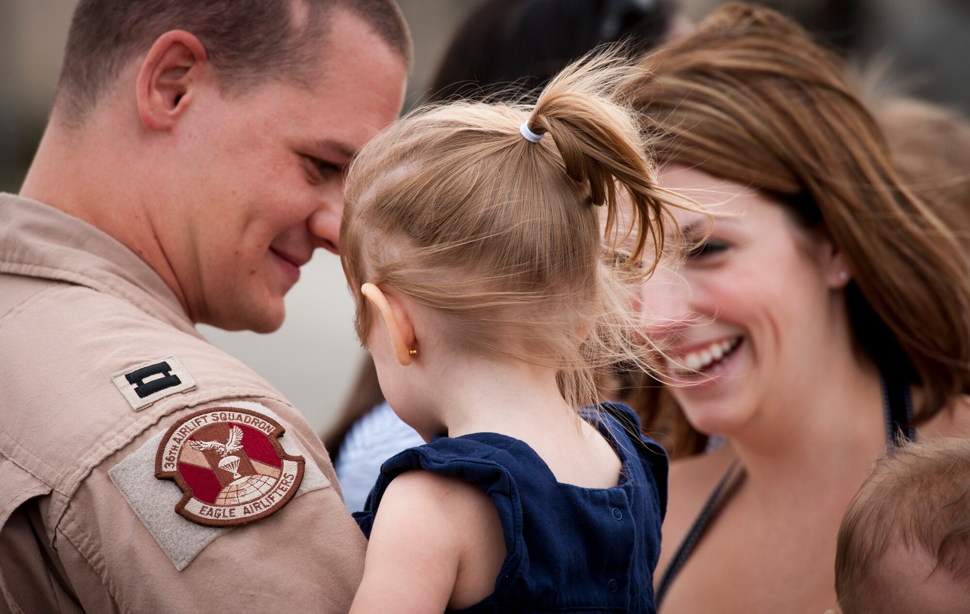 YOKOTA AIR BASE, Japan -- Capt. Jeremy Hauge, 36th Airlift Squadron instructor navigator, reunites with his family at Yokota Air Base, Japan, June 15, 2011. Captain Hauge spent four months deployed to Southwest Asia. (U.S. Air Force photo/Staff Sgt. Samuel Morse)