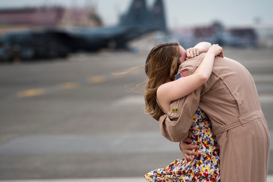 YOKOTA AIR BASE, Japan -- Chelsea Metros hugs her husband, Capt. George Metros, for the first time in four months at Yokota Air Base, Japan, June 15, 2011. Captain Metros piloted airlift missions during a deployment Southwest Asia with other members of the 36th Airlift Squadron. (U.S. Air Force photo/Staff Sgt. Samuel Morse)