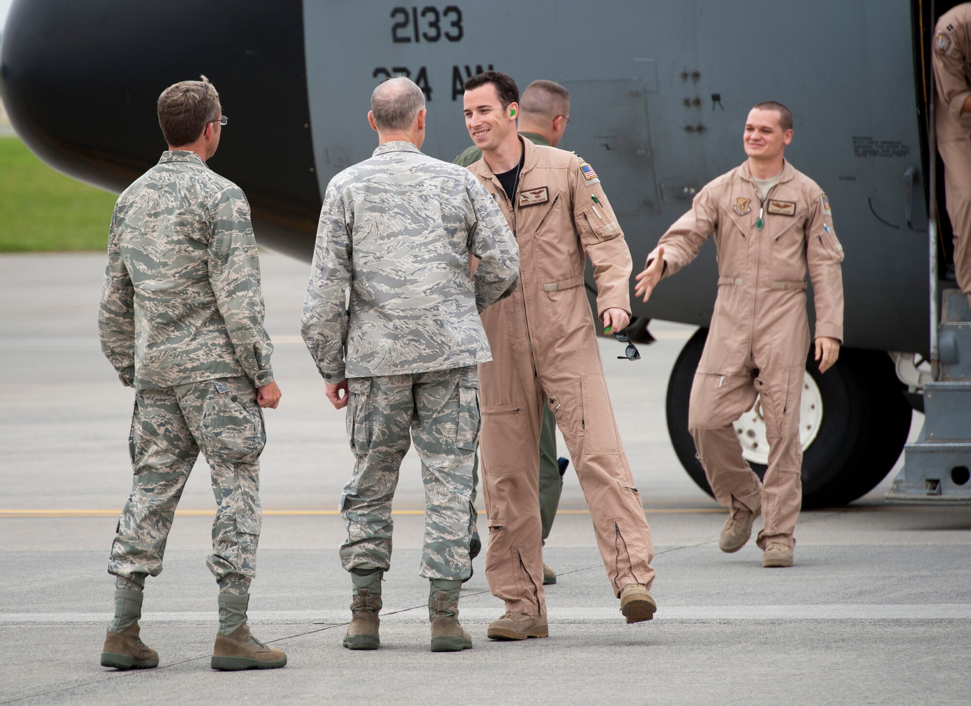 YOKOTA AIR BASE, Japan -- Col. Otto Feather (center), 374th Airlift Wing commander, along with other wing leadership, welcome members of the 36th Airlift Squadron back to Yokota Air Base, Japan, June 15, 2011. The returning Airmen conducted airlift missions in Southwest Asia. (U.S. Air Force photo/Staff Sgt. Samuel Morse)