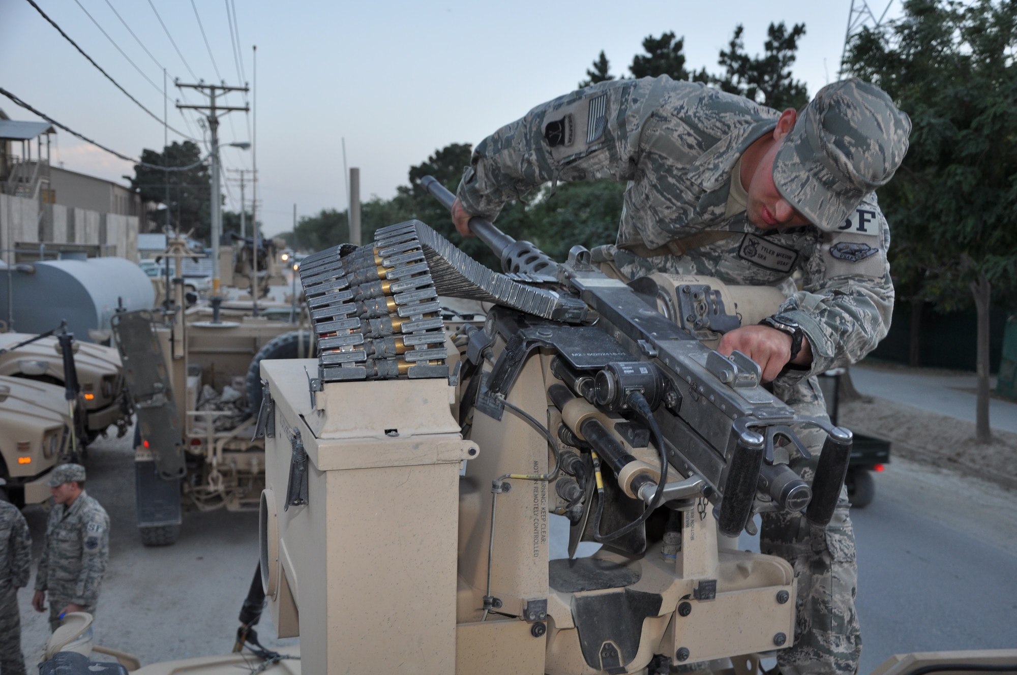 BAGRAM AIRFIELD, Afghanistan --  BAGRAM AIRFIELD, Afghanistan – Senior Airman Tyler McEuin, 455th Expeditionary Security Forces Squadron Quick Response Team Common Remotely Operated Weapon Station operator, inspects a .50 caliber mounted on top of his vehicle before setting off on a mission here June 6. The CROWS allows Airman McEuin to operate the weapon using a video screen and joystick from the safety of inside an armored assault vehicle. (U.S. Air Force photo by Staff Sgt. John Wright)