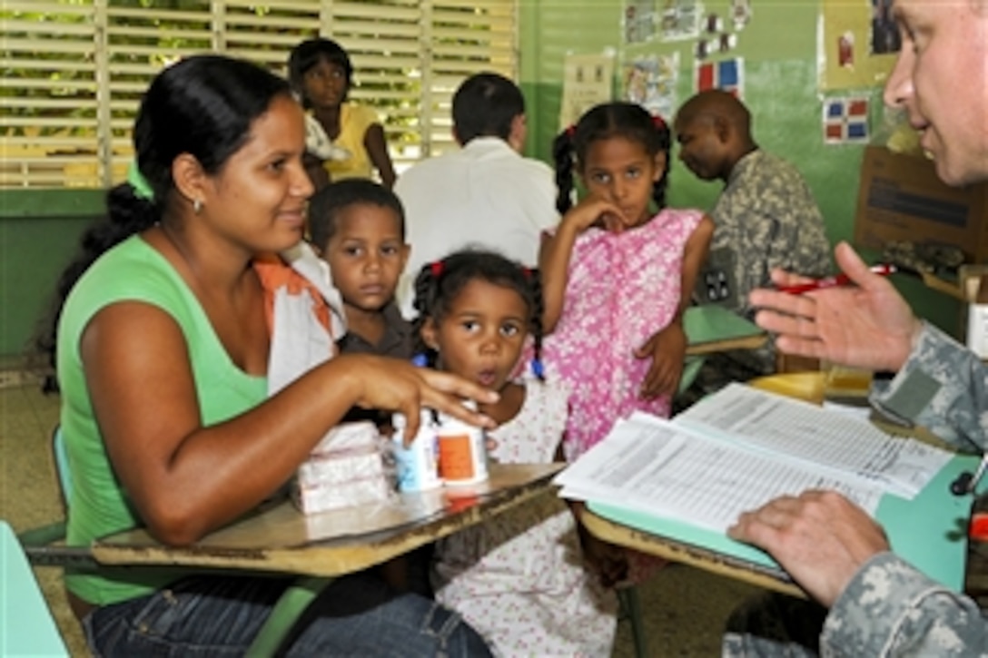 U.S. Army Maj. Dr. Matthew Johnson talks to a Dominican mother about medication doses during a medical readiness training exercise in Esperanza, Dominican Republic, on June 4, 2011.  Johnson is a physician assigned to the 228th Combat Support Hospital.  