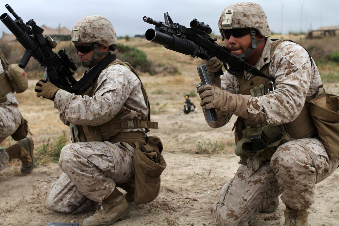 Cpl. Manuel E. Pardo and Sgt. Ricardo Espinosa practice reloading their rifles here June 16, during the 11th Marine Expeditionary Unit's first full-scale exercise since coming together in May. The Marines are both vehicle commanders with combined anti-armor team 2, Weapons Company, Battalion Landing Team 3/1. Pardo, 22, is from Santa Clarita, Calif. Espinosa, 25, is from Chicago.