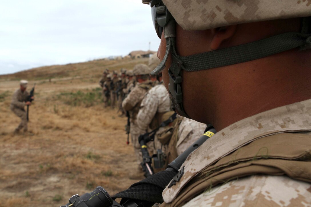 Marines with combined anti-armor aeam 2, Weapons Company, watch a weapon clearing demonstration here June 16, during the 11th Marine Expeditionary Unit's first full-scale exercise since coming together in May. The company is a part of Battalion Landing Team 3/1, the ground combat element for the MEU.