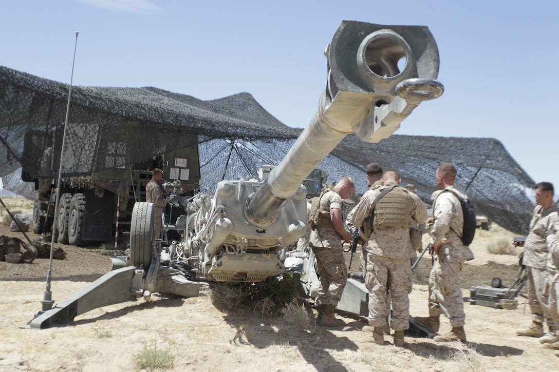 Marines with 2nd Battalion, 10th Marine Regiment, get ready to fire the M777 A2 Howitzer with the excalibur round June 17, 2011, in the Combat Center’s Emerson range training area. The majority of the battalion has never fired the excalibur round before.::r::::n::