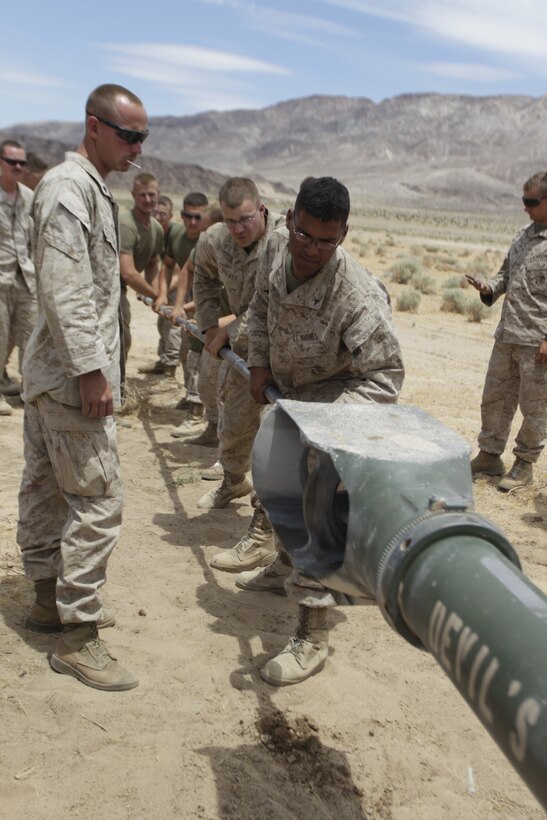 Marines with 2nd Battalion, 10th Marine Regiment clean the barrel of the M777 A2 Howitzer, in the Combat Center’s Emerson range training area June 17, 2011.::r::::n::