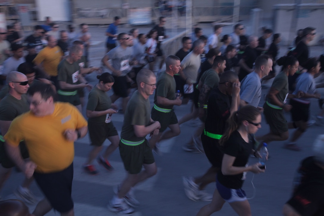 Marines and sailors take off at the start of the U.S. Navy Hospital Corps’ 113th birthday celebratory run at Kandahar Airfield, Afghanistan, June 17.