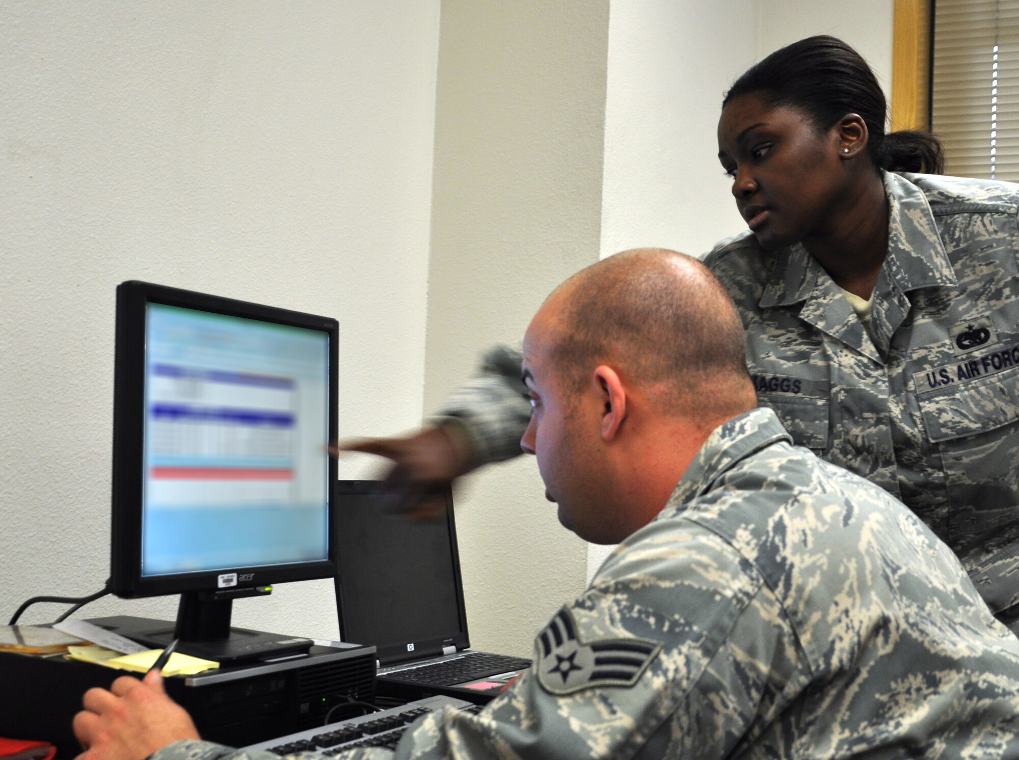 U.S. Air Force Staff Sgt. Tamara Skaggs, 67th Aircraft Maintenance Unit supply non-commissioned officer in charge, right, instructs Senior Airman Sean Finnegan, 67th AMU supply technician, in rearranging mission capable, or MICAPS, aircraft parts during the Northern Edge Premier Joint Training Exercise, June 16, 2011 at Eielson Air Force Base, Alaska.  MICAPS are parts needed to make a grounded aircraft mission ready and are essential to the mission of the 67th AMU, which is based out of Kadena Air Base, Japan. (U.S. Air Force photo by Staff Sgt. Amanda Dick)