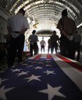 Joint military members from the island of Oahu transfer the remains of a U.S. service member, recovered by the Joint Pacific Accounting Command, during an arrival ceremony on Joint Base Pearl Harbor-Hickam, Hawaii June 17. Three flag draped caskets carried military members from World War II and the Vietnam War. The remains were recovered in Laos, Vietnam and Papua New Guinea. Following the ceremony with full military honors, the remains will be sent to JPAC's Central Identification Laboratory where forensic identification analysis will be conducted so the remains may be identified and returned to the members family. (U.S. Air Force photo/Senior Airman Lauren Main)
