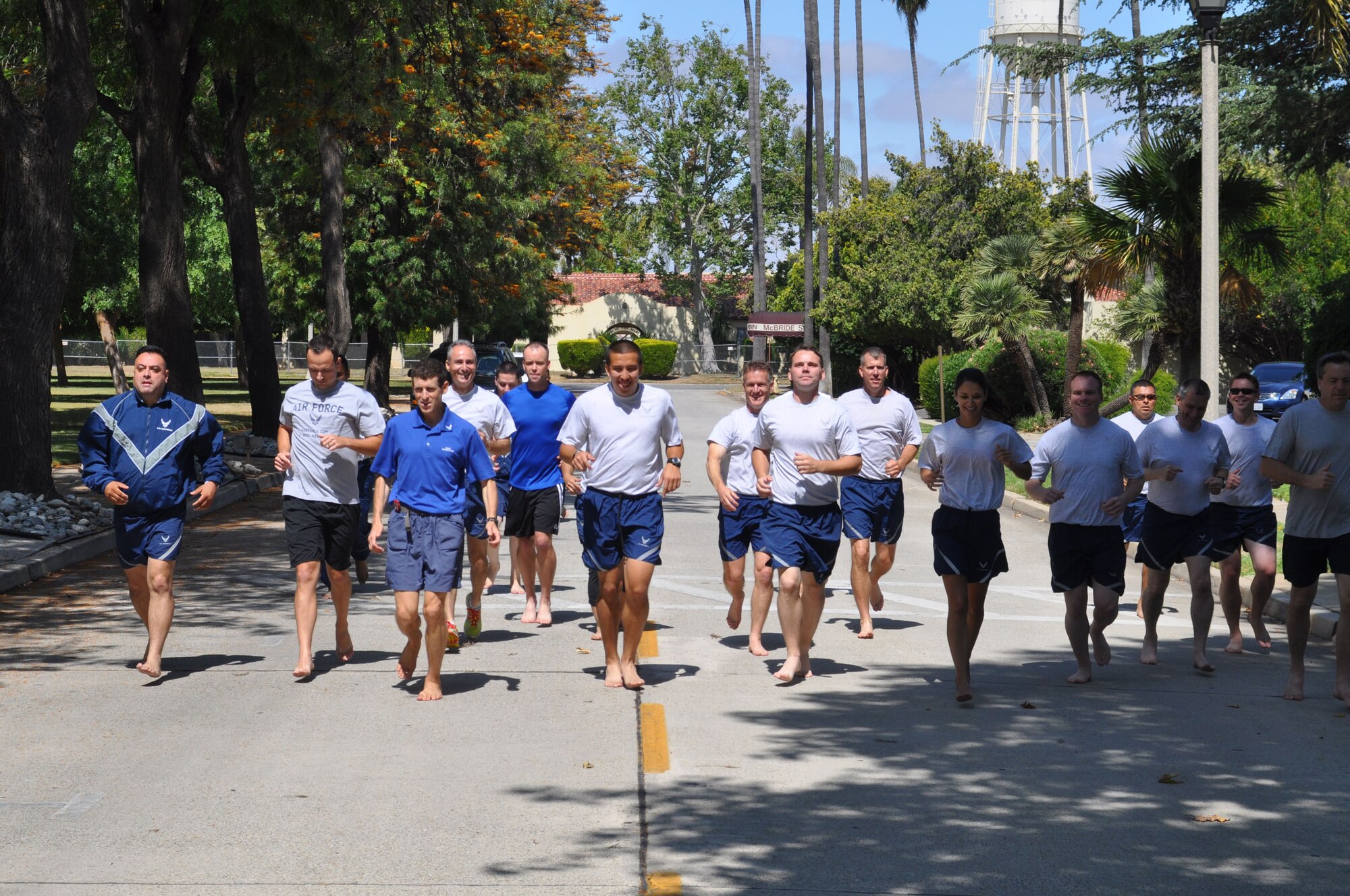 A group of Airmen give barefoot running a try with Dr. Dr. Mark Cucuzzella, the chief medical consultant for the Air Force Marathon and 2006 Air Force Marathon winner, during a running clinic at March Air Reserve Base, Calif., June 12, 2011.  The clinic was a joint effort between the 452nd Air Mobility Wing and the March FITT organization. (U.S. Air Force photos/Staff Sgt. Kevin Chandler)