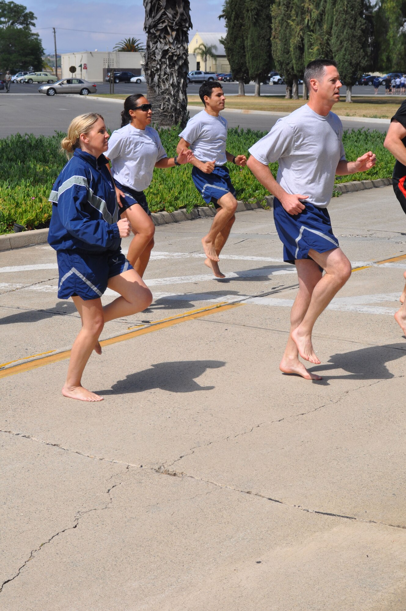 Runners practice a drill during a running clinic at March Air Reserve Base, Calif., June 12, 2011.  The clinic was a joint effort between the 452nd Air Mobility Wing and the March FITT organization. (U.S. Air Force photos/Staff Sgt. Kevin Chandler)