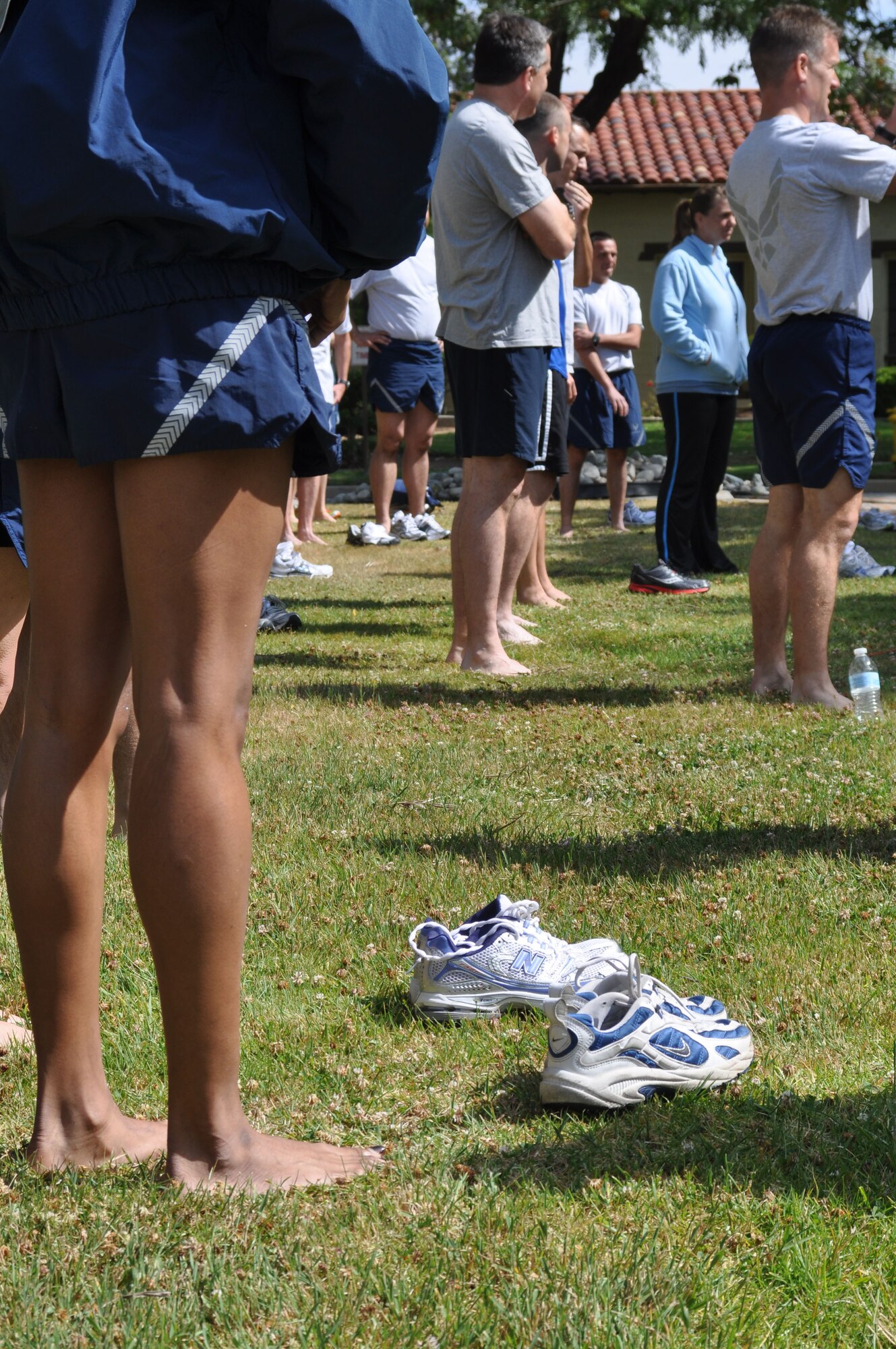 Runners stand barefoot in the grass in front of the Hap Arnold Club during a running clinic at March Air Reserve Base, Calif., June 12, 2011.  The clinic was a joint effort between the 452nd Air Mobility Wing and the March FITT organization. (U.S. Air Force photos/Staff Sgt. Kevin Chandler)