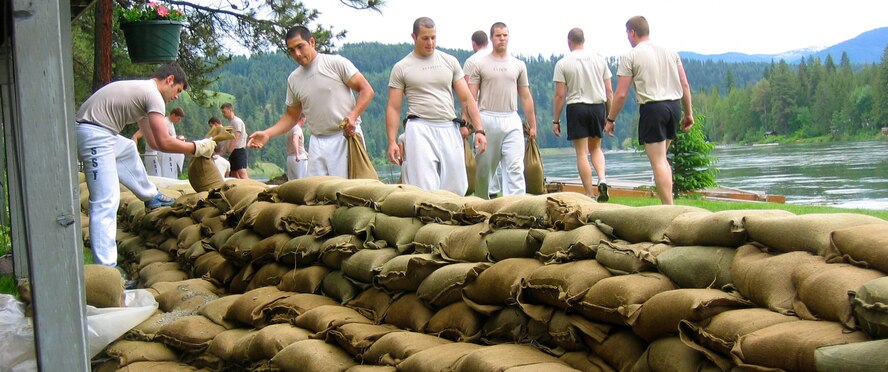 Forty student candidates and instructors from the 336th Training Group Survival, Evasion, Resistance and Escape School at Fairchild Air Force Base, Wash., filled about 10,000 sandbags in Pend Oreille County, Wash. on June 9, 2011, reportedly saving three homes from being flooded. This photo shows people loading sandbags  in the affected areas. (Courtesy Photo)