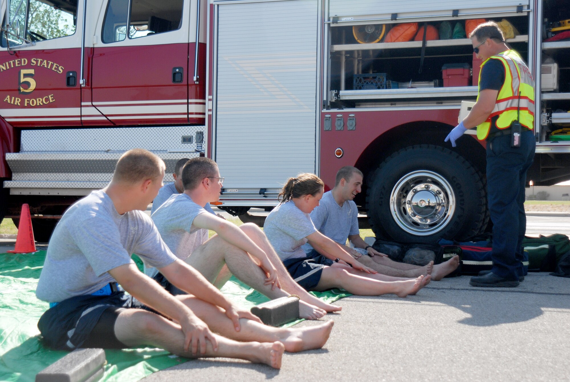 GOODFELLOW AIR FORCE BASE, TEXAS--Students from the 316th and 315th Training Squadrons are instructed by Glenn Haffner, 17th Civil Engineer Squadron assistant chief, on steps of the decontamination process during the exercise June 16. The scenario for the exercise was an unknown assailant tossed gas canisters into the theater contaminating those inside. (U.S. Air Force photo/Airman 1st Class Michael Smith)