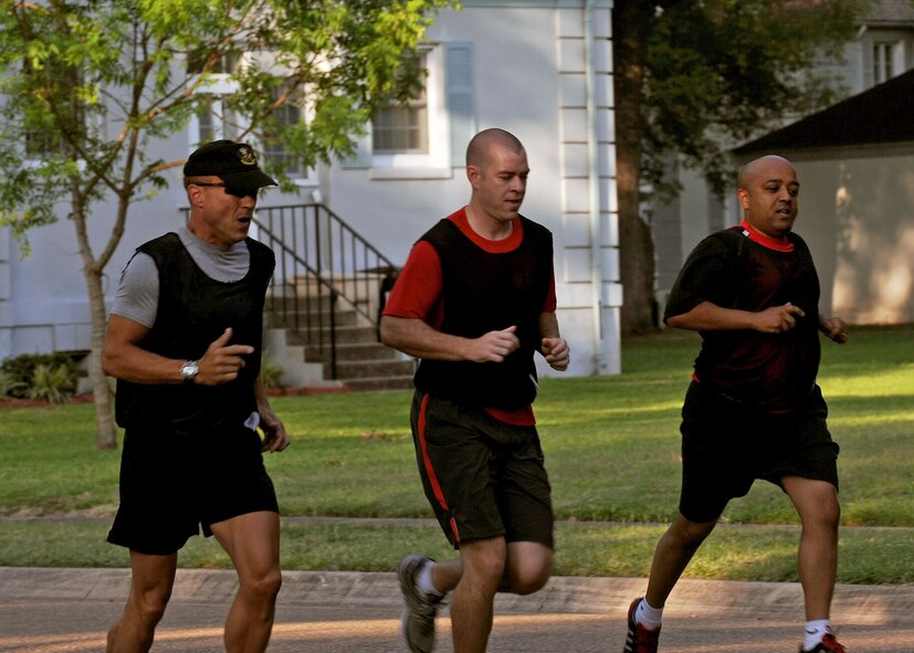 Members of Air Force Global Strike Command A6 team, run through Barksdale's Historic Housing area during the "Amazing Race" challenge held at Barksdale Air Force Base, La., June 16. This was one of many routes taken by different teams as they progressed to the next station. (U.S. Air Force photo/Senior Airman La'Shanette V. Garrett) (RELEASED)