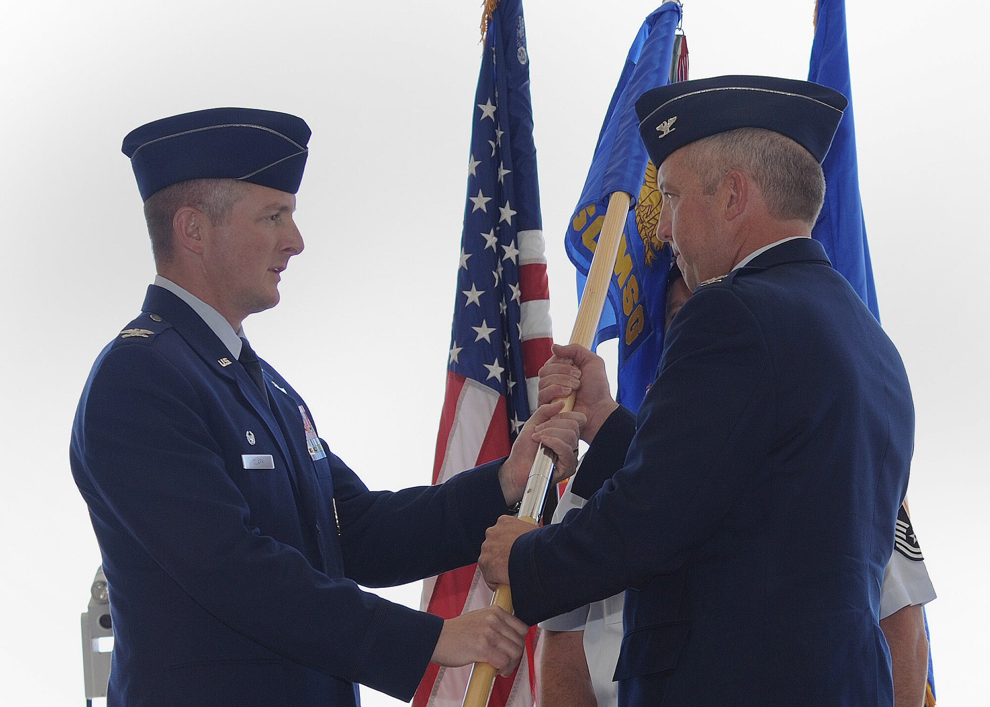 U.S. Air Force Col. Stephen Clark, 27th Special Operations Wing commander, hands the guidon to Col. David Piech, 27th Special Operations Mission Support Group commander, in a change of command ceremony at Cannon Air Force Base, N.M., June 17, 2011. The primary mission of the 27 SOMSG is to provide combat support and base sustainment services to ensure the mission readiness of the 27 SOW. (U.S. Air Force photo by Senior Airman James Bell)